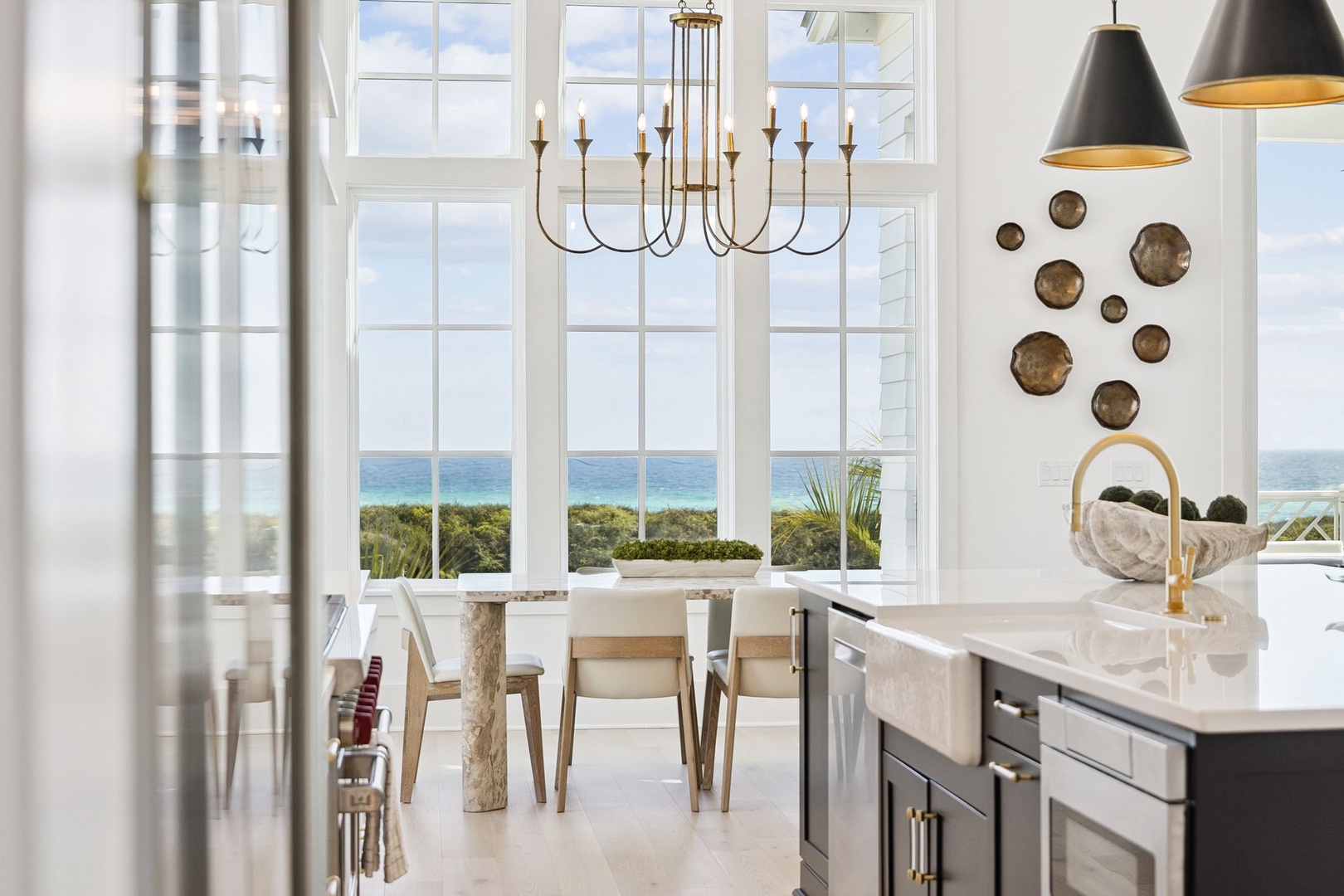 Your kitchen opens to stunning ocean views, where marble counters and gold fixtures create an elegant cooking space with breathtaking sea vistas.