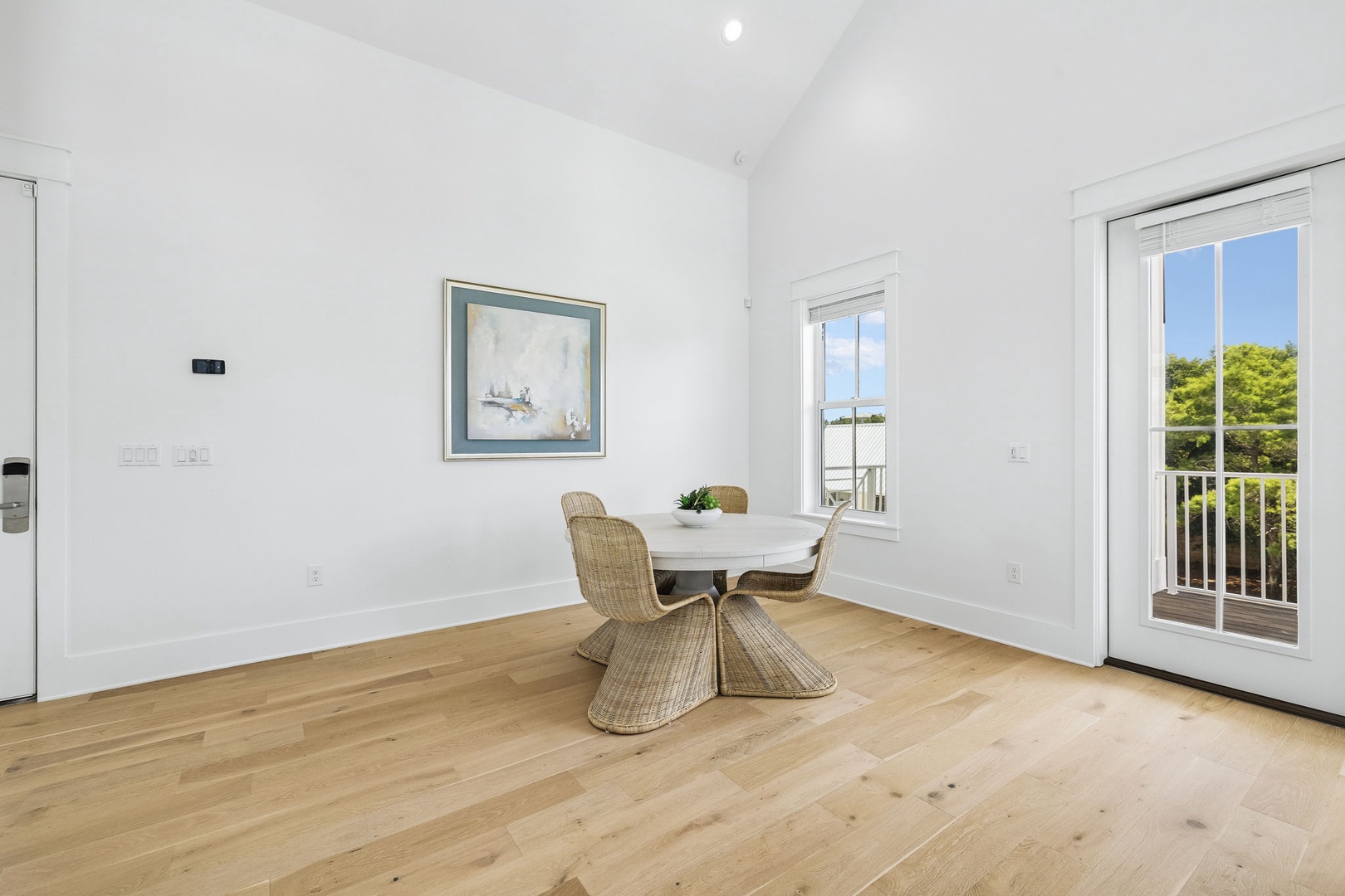 Sunlight pours through the windows, illuminating your airy dining space with its soaring ceilings and warm wood floors. Step out to your private balcony for morning coffee or evening relaxation.