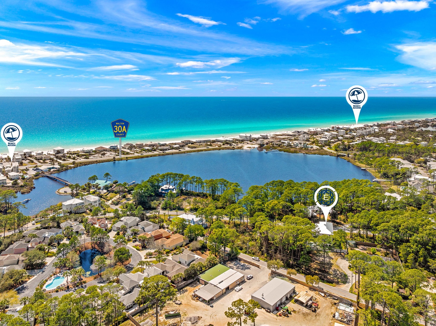Stunning aerial view showcasing the coastal community's prime location between pristine beaches and serene inland waterways.