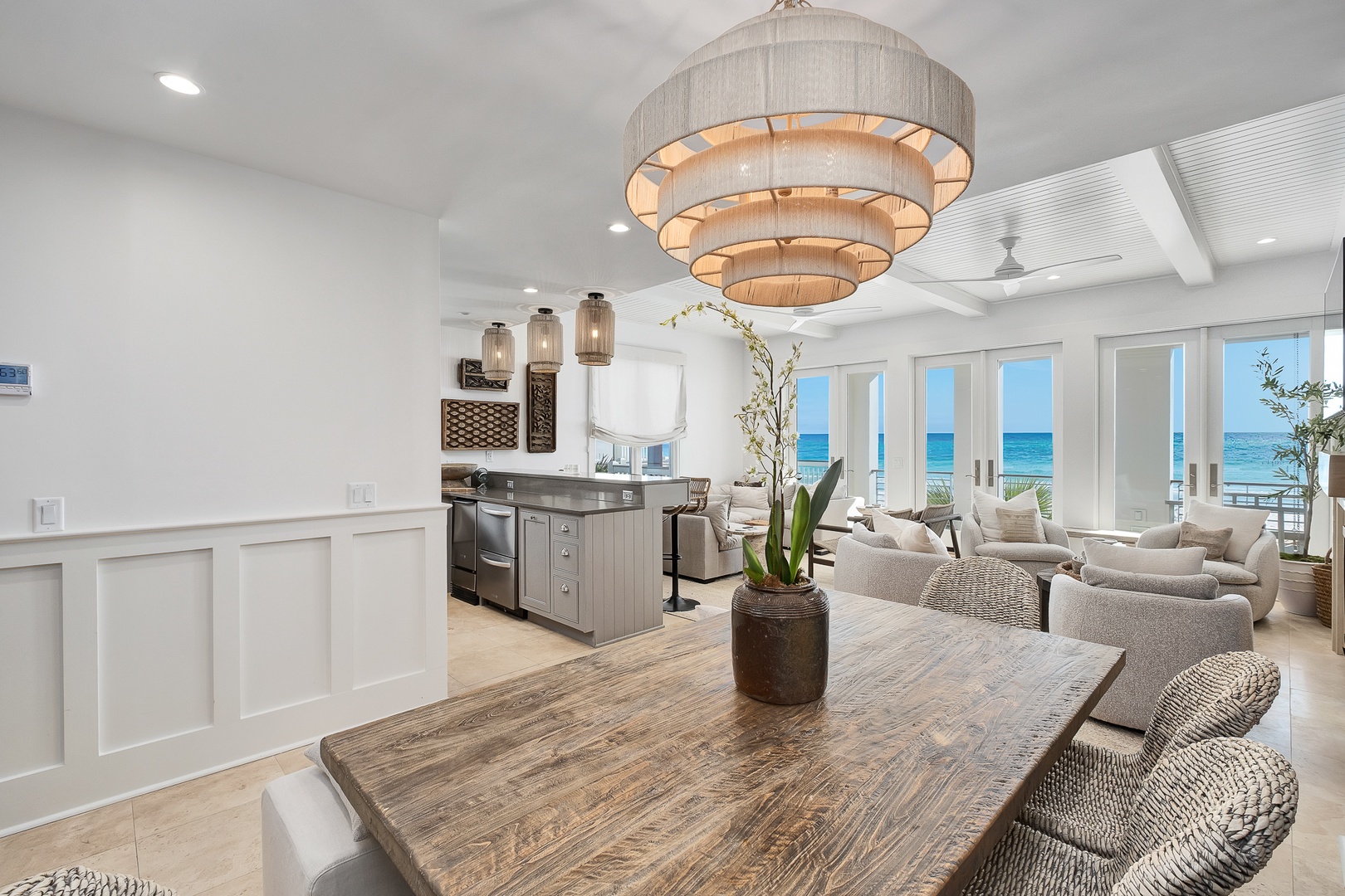 Relax in your stunning open-plan living space where coastal elegance meets modern comfort, complete with ocean views through expansive windows.