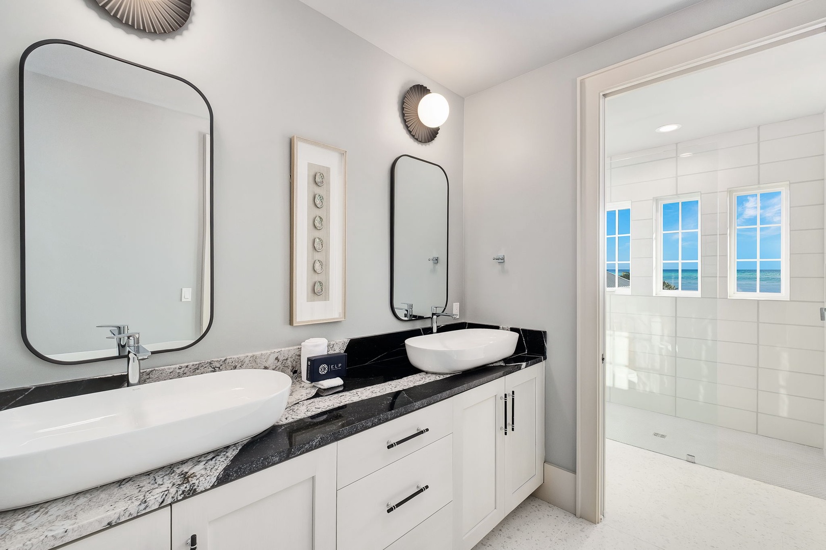 Unwind in your spa-like ensuite with dual vanities, rainfall shower, and stunning ocean views through frosted windows.