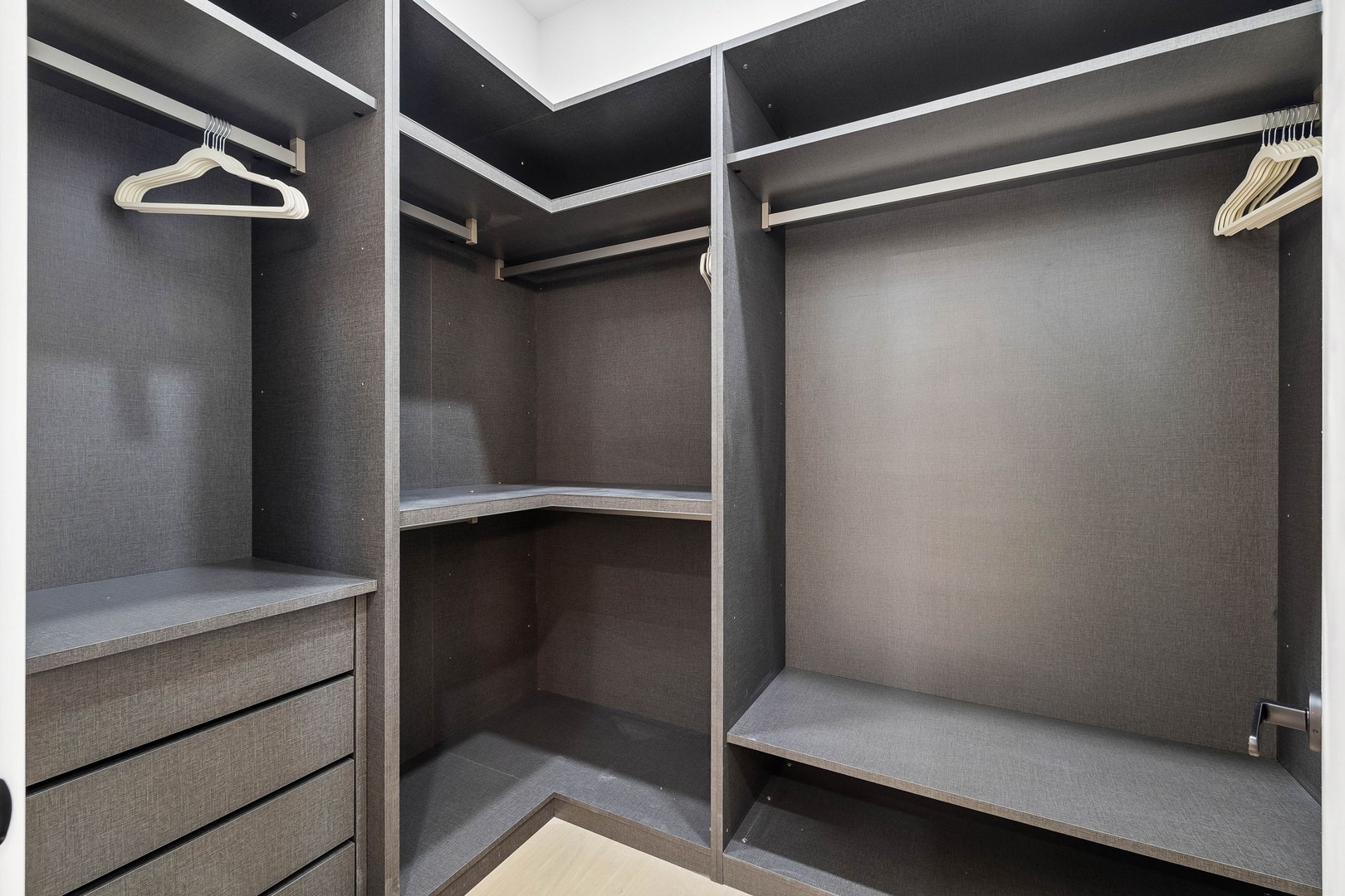 Your private walk-in closet offers plenty of room to unpack and settle in, with sleek shelving, hanging rods, and built-in drawers to keep everything organized throughout your stay.