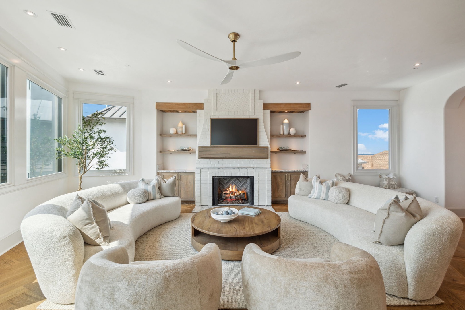 Settle into plush seating and unwind by the warmth of your gas fireplace. Bright windows, custom built-ins, and airy elegance create your perfect retreat.