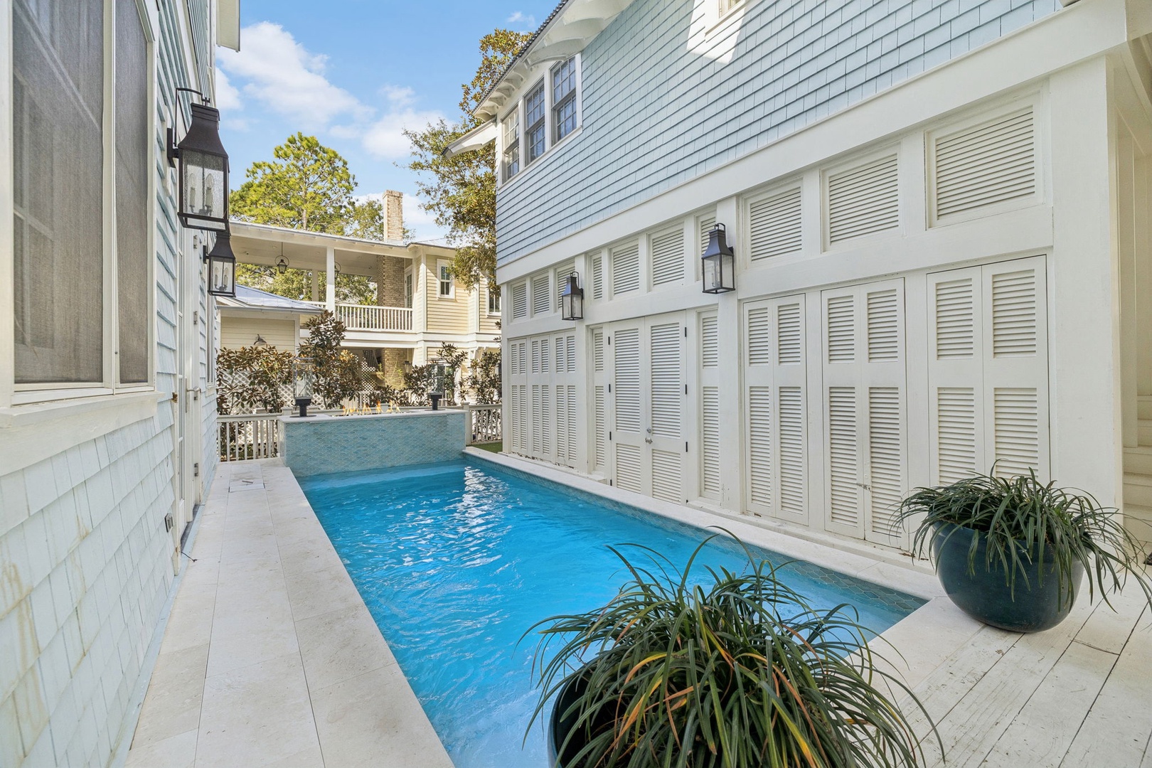 Your private pool awaits between elegant white buildings, creating a serene courtyard oasis for refreshing swims and poolside relaxation.