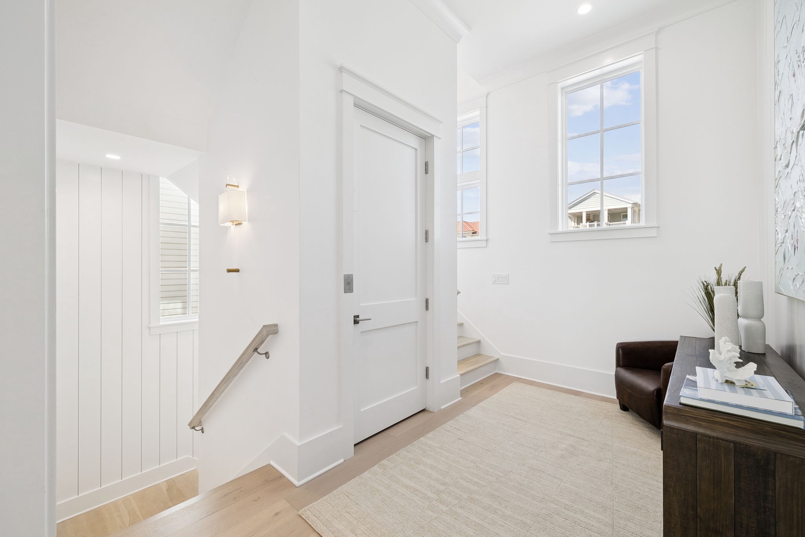 Step into your bright, welcoming entryway where natural light streams through elegant windows and clean lines create a serene atmosphere.