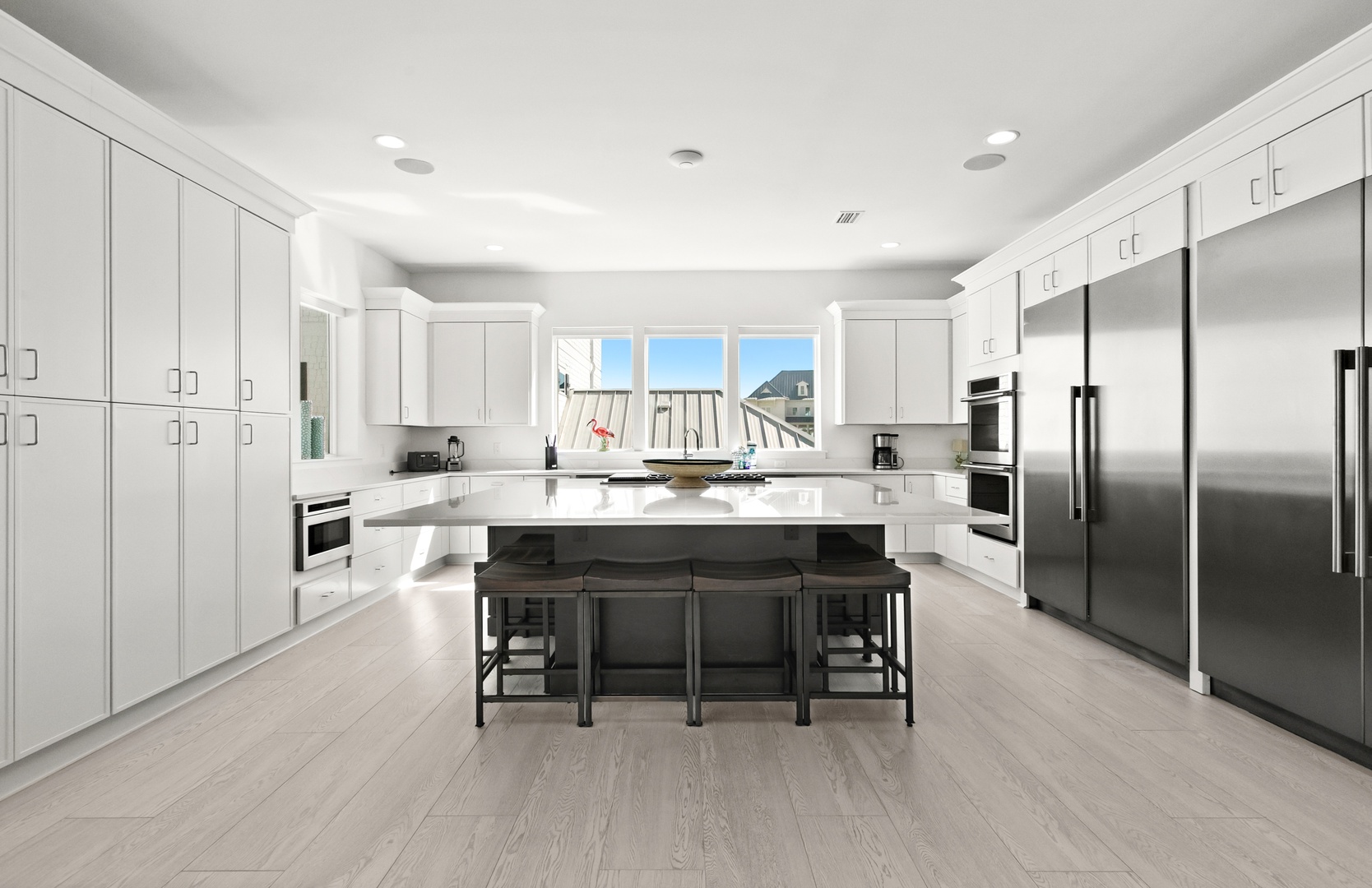 This bright, modern kitchen invites you to gather and create. Gleaming countertops, generous storage, and professional-grade appliances make cooking effortless, while the spacious island offers room for everyone to join in.