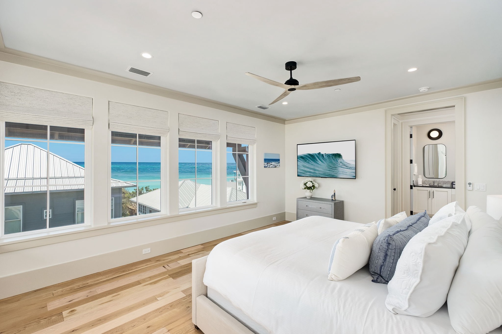 Wake up to stunning ocean views from your private bedroom sanctuary, where crisp white linens and coastal breezes create your perfect retreat.