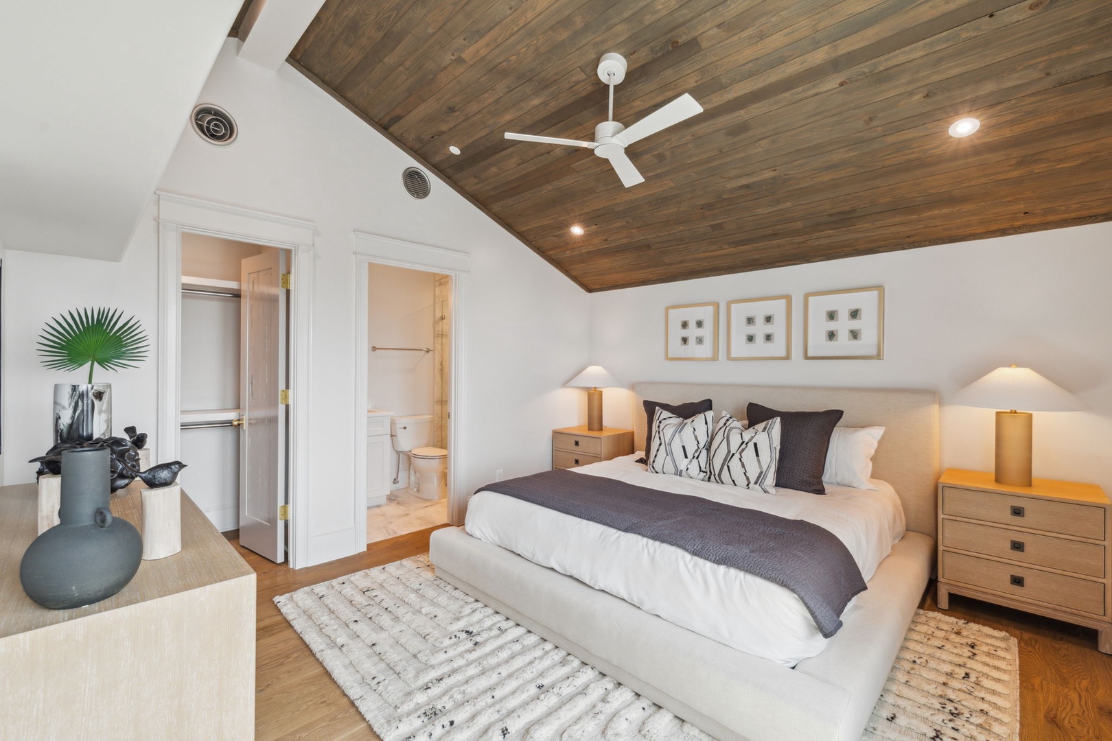 Step into your serene retreat with a plush bed, warm wood ceiling, and soft lighting that cradles you in comfort after a day of exploring.