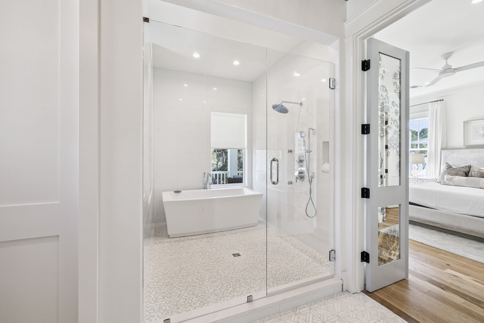 Step into your private spa retreat with a luxurious soaking tub and rainfall shower in pristine white marble.