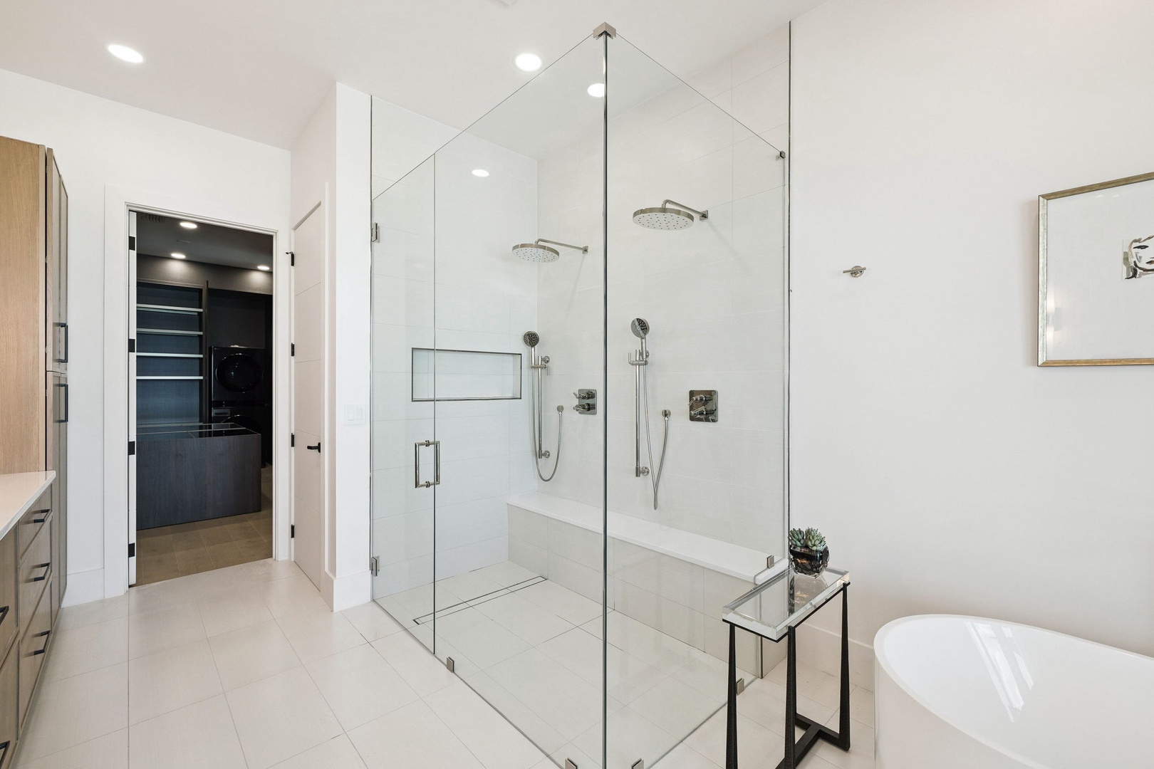 Step into your luxurious ensuite, where dual rainfall showers and a sleek soaking tub invite you to unwind after a long day of exploring.