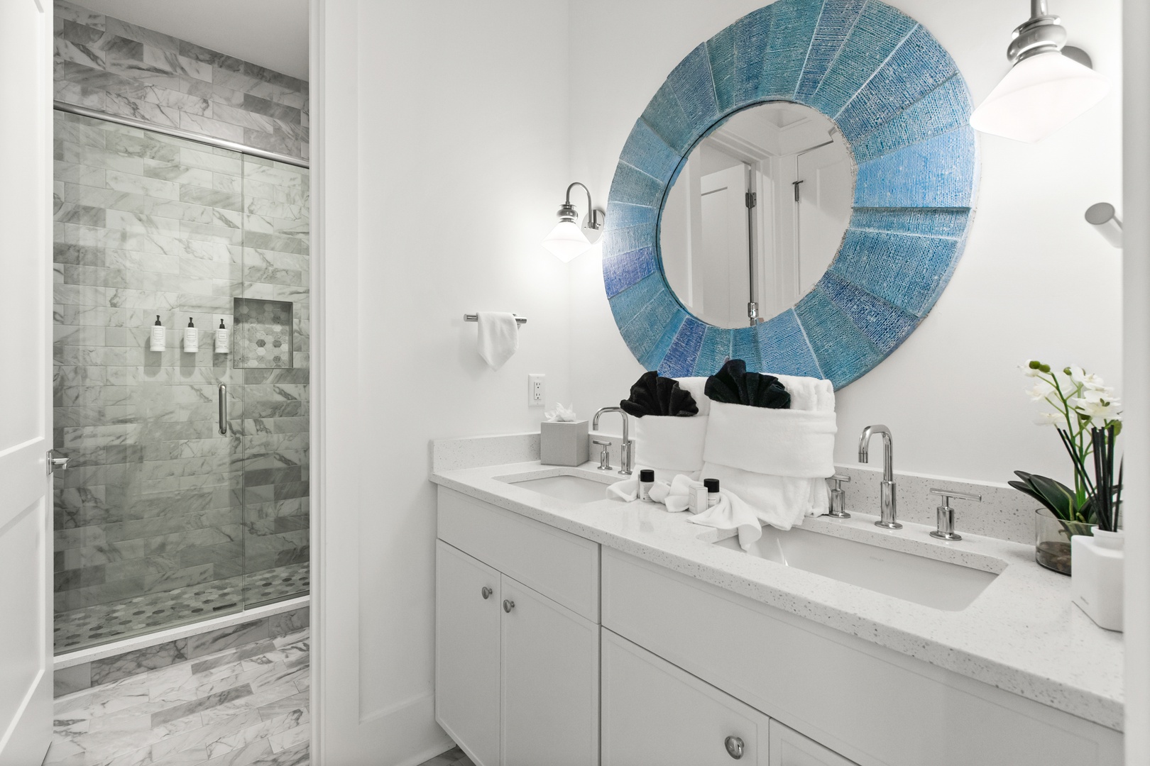 Your private bathroom retreat features marble-tiled shower, coastal-inspired décor, and spa-quality amenities for ultimate relaxation.