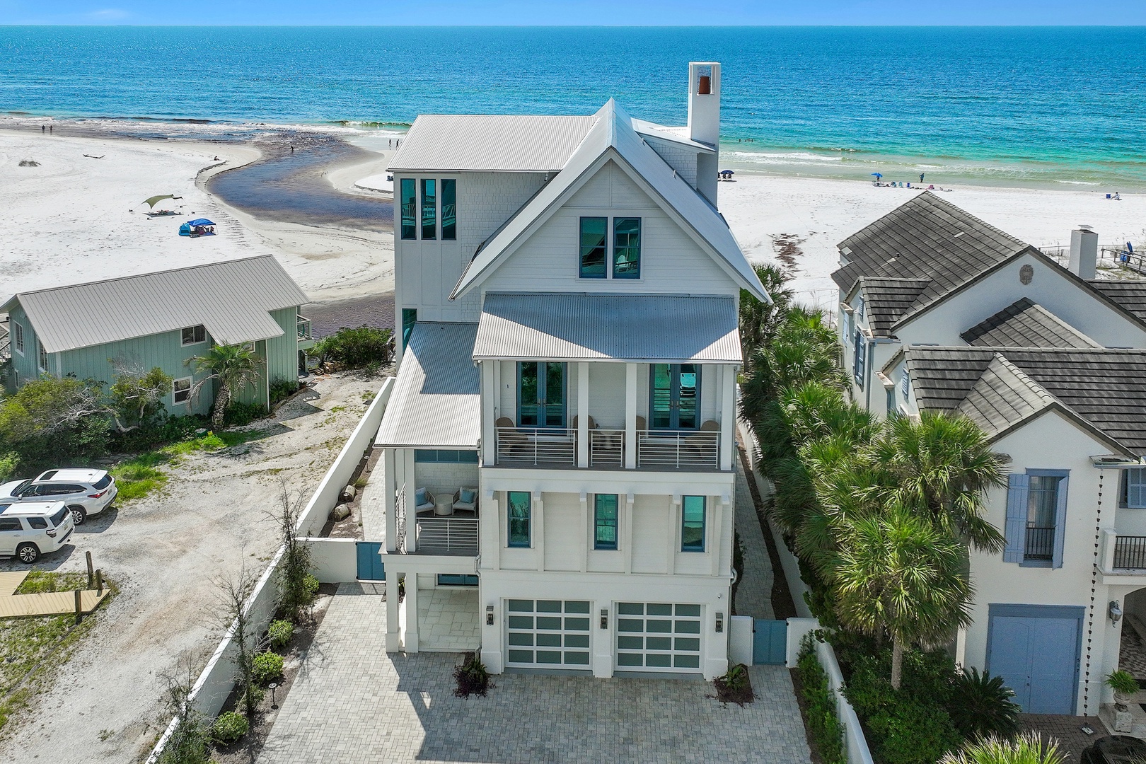 This stunning beachfront home sits mere steps from white sand and turquoise waters, offering an unforgettable coastal escape. The property's elevated design and modern architecture frame sweeping Gulf views from multiple levels.