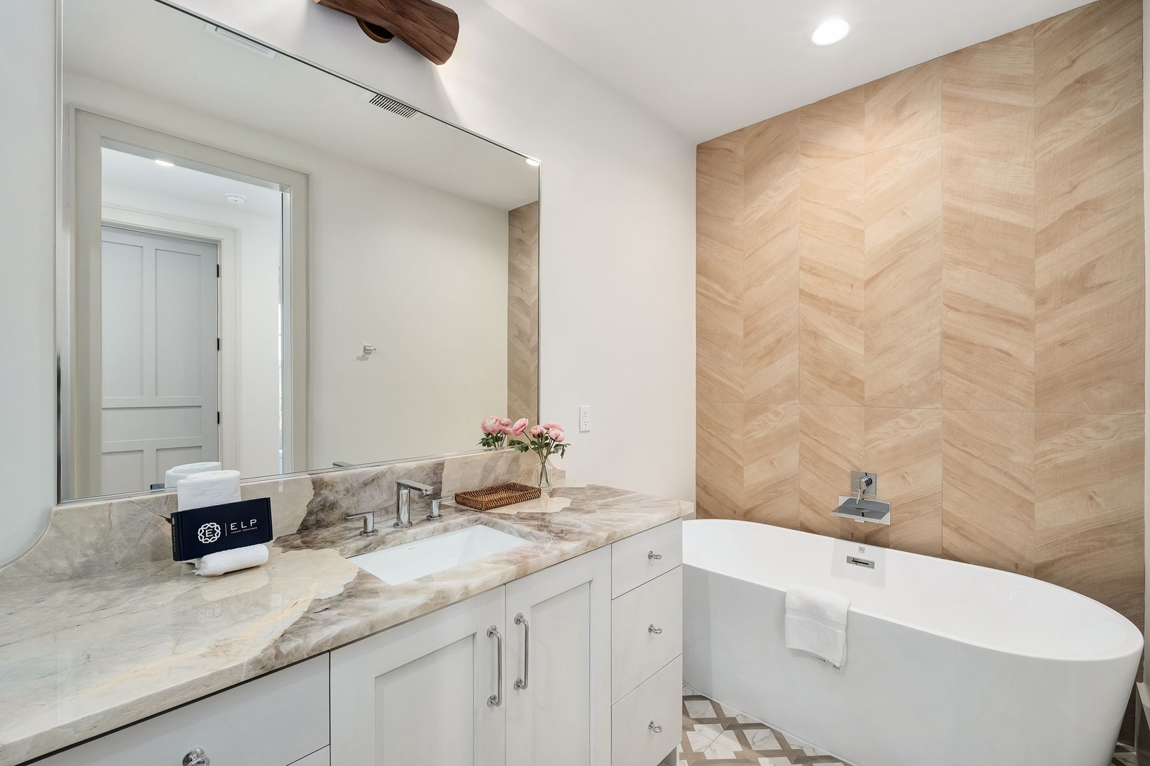 Unwind in your luxurious spa-style bathroom with elegant marble vanity and soaking tub—your perfect retreat after exploring.