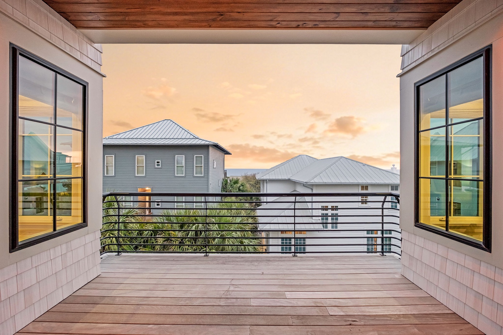 Step onto your private balcony and soak in golden sunset views over the neighborhood from this beautifully designed outdoor retreat.