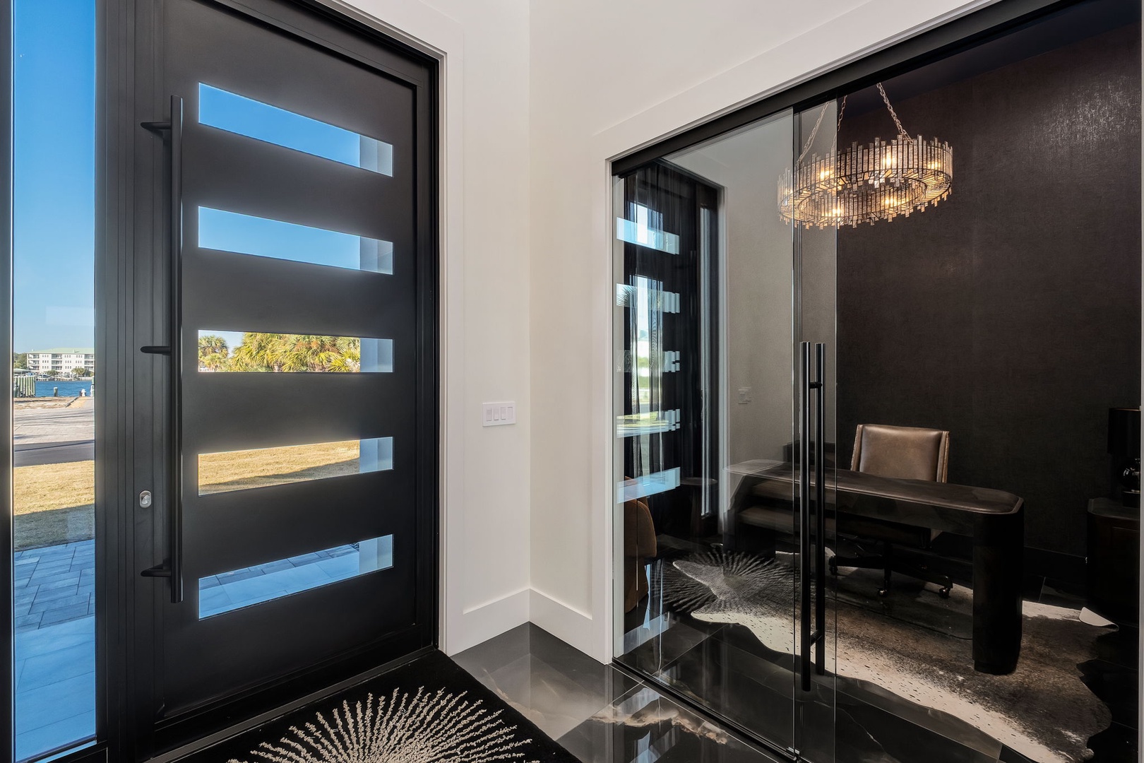 Step into your sophisticated entryway with sleek modern design, polished floors, and elegant dining space.