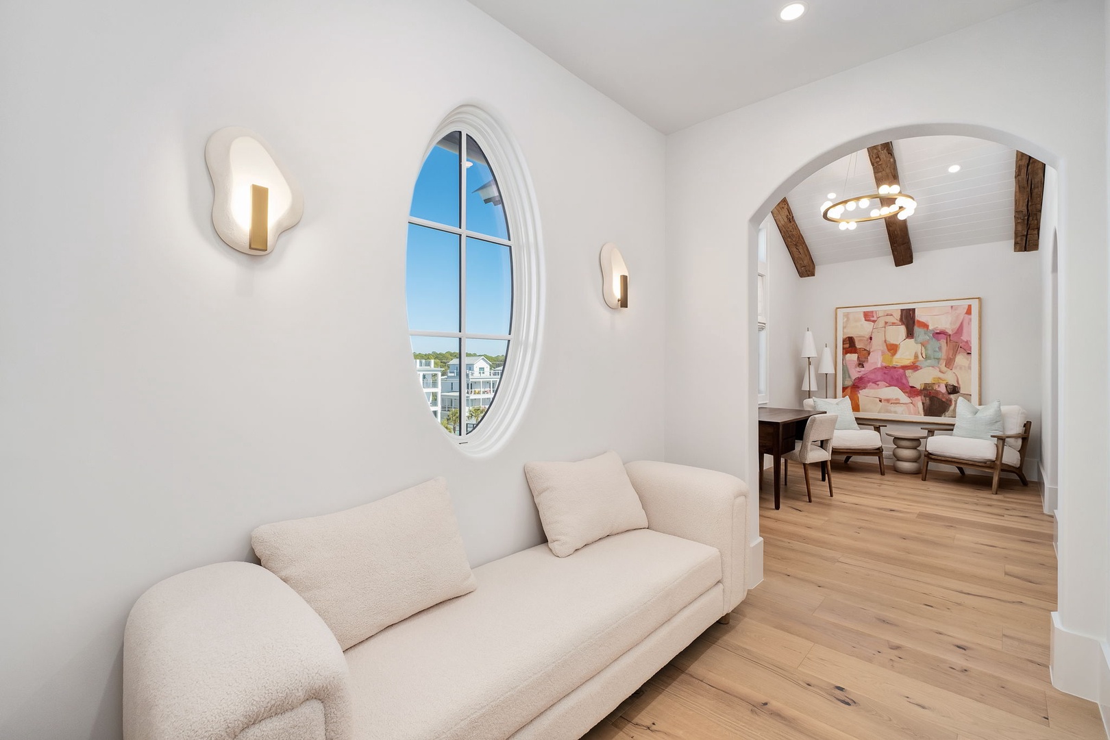 Unwind in your elegant living space where modern comfort meets architectural charm through stunning arched doorways and warm natural light.