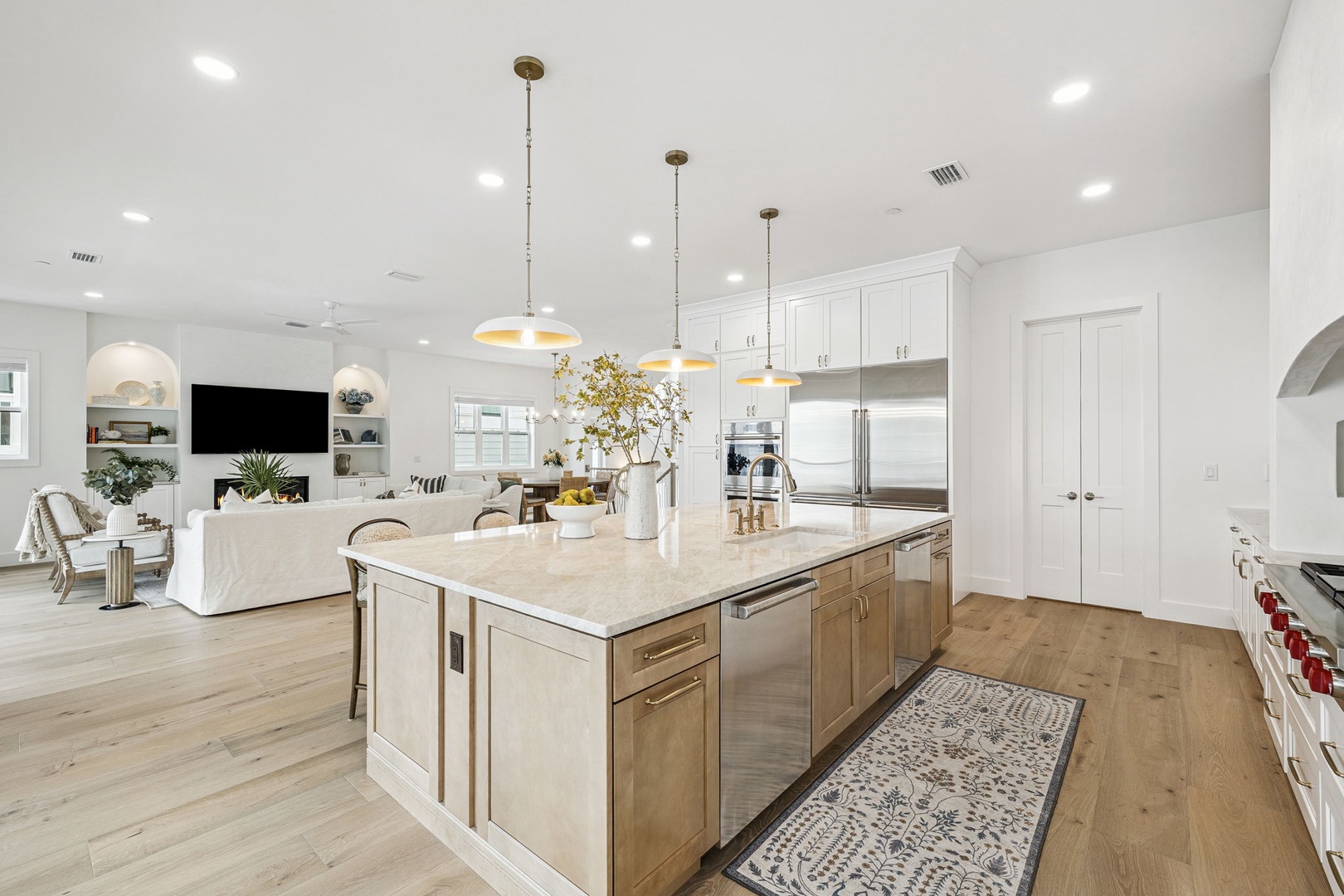 Step into your bright, spacious kitchen where marble countertops and warm wood floors create the perfect space for cooking memorable meals together.
