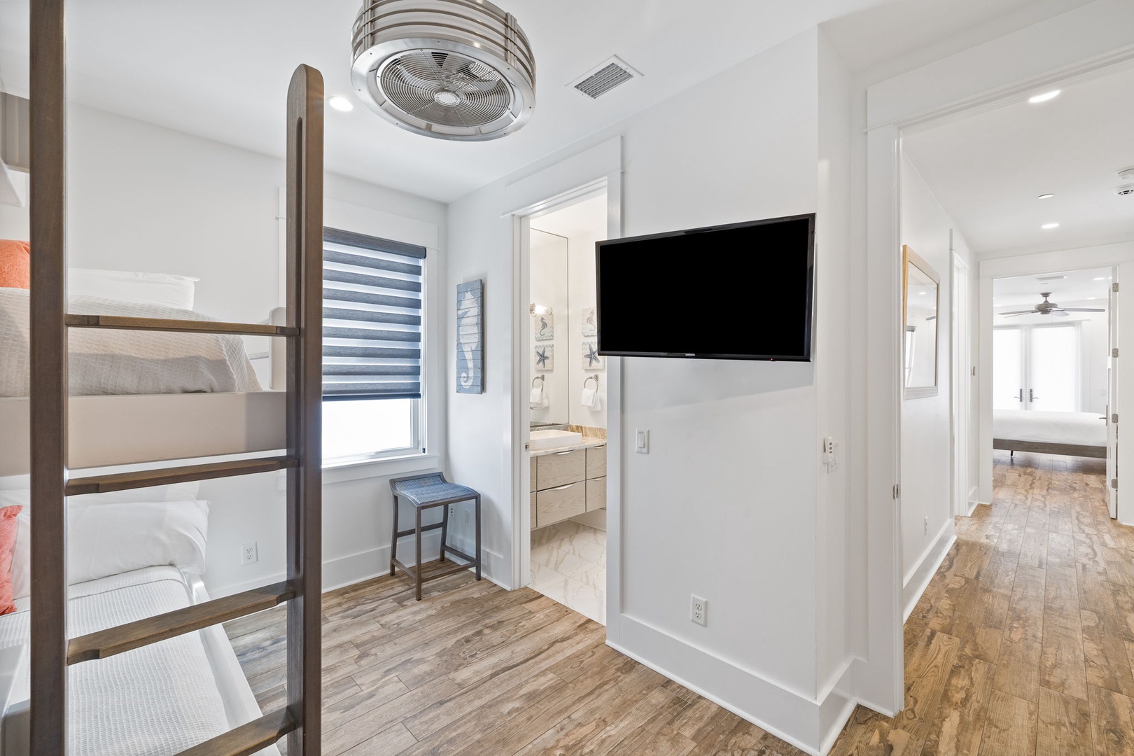 Your cozy bedroom features a space-saving bunk bed and wall-mounted TV for comfort and entertainment after exploring.