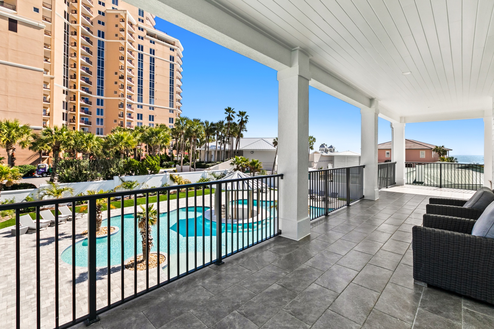 Relax in your private balcony chairs while soaking in views of the shimmering pool, swaying palms, and sparkling Gulf waters just beyond.