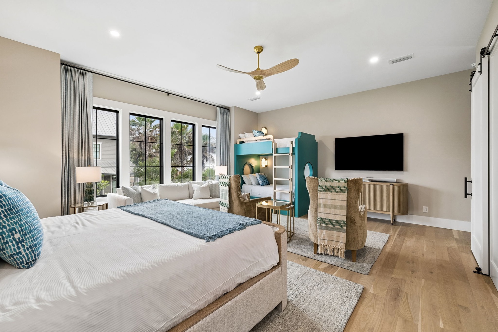 Sink into the plush bed after a day of exploring, while kids claim their cozy bunk nook. Large windows flood your space with light, revealing leafy views.
