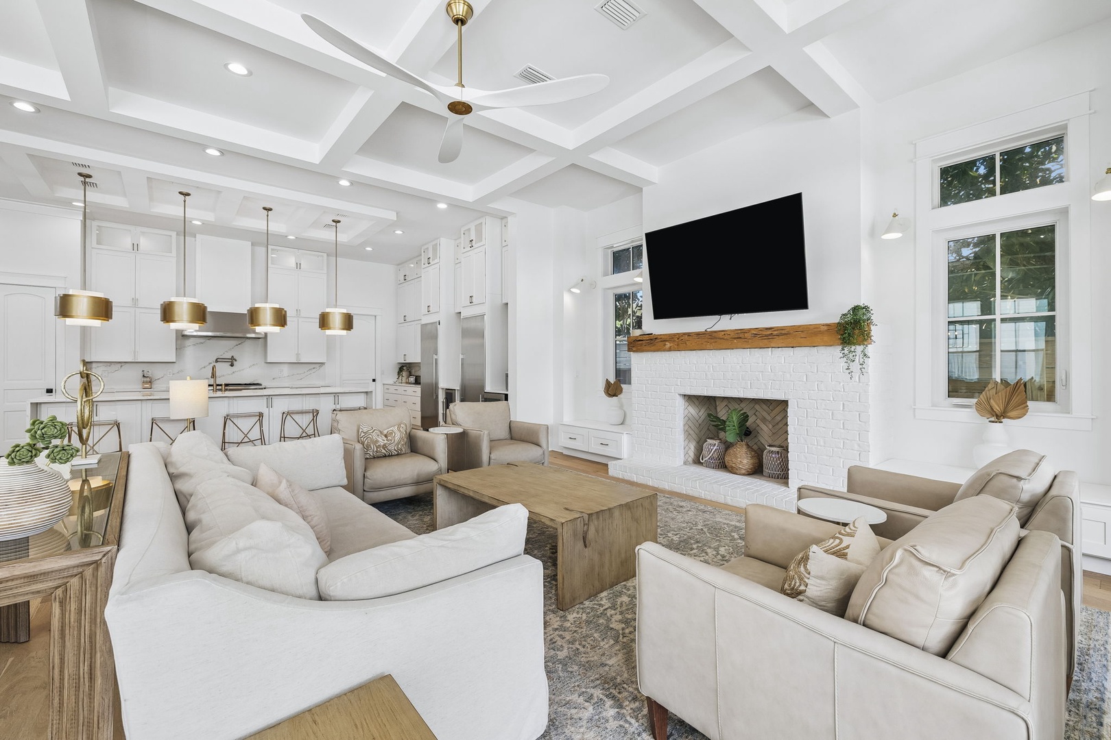 Sink into plush seating in this bright, open living space where soaring ceilings and warm wood accents create an inviting atmosphere. Your perfect home base for relaxation awaits.