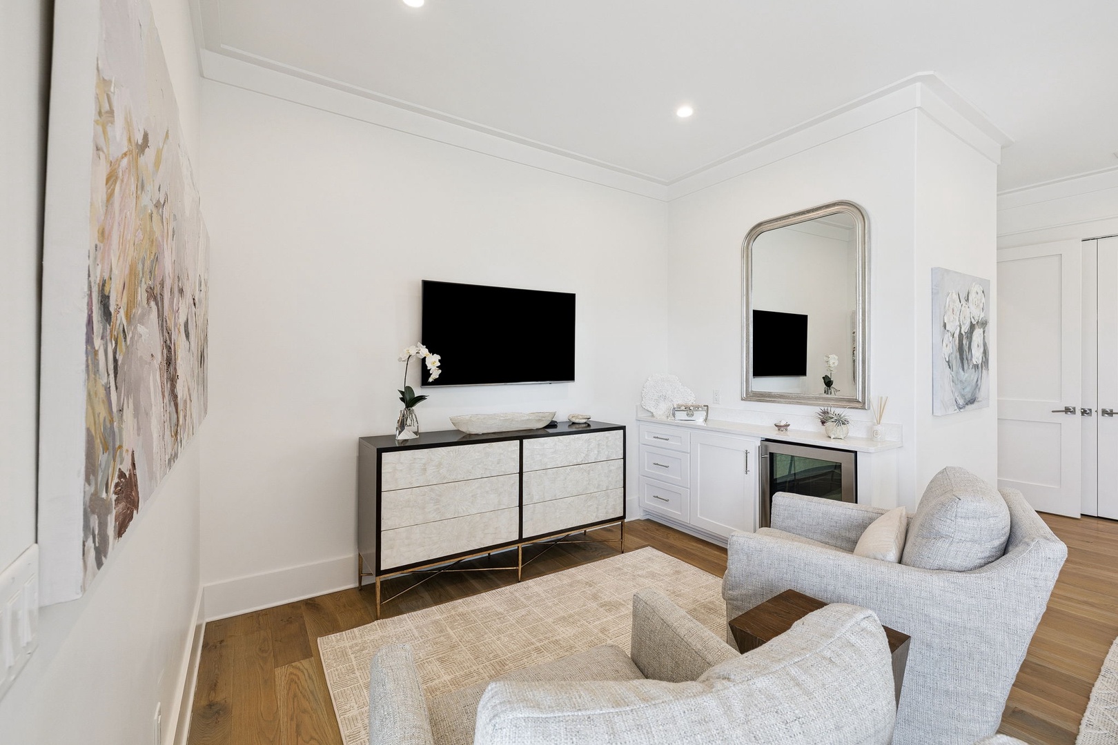 Relax in your elegant living space with modern furnishings, wall-mounted TV, and sophisticated décor creating the perfect atmosphere for unwinding.