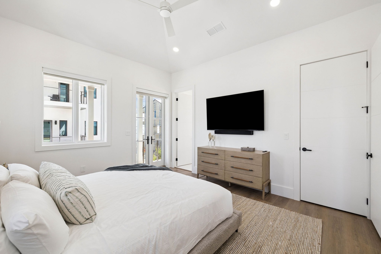 Relax in your serene bedroom with crisp linens, a calming white palette, and a private balcony where you can step outside to breathe in the fresh air.