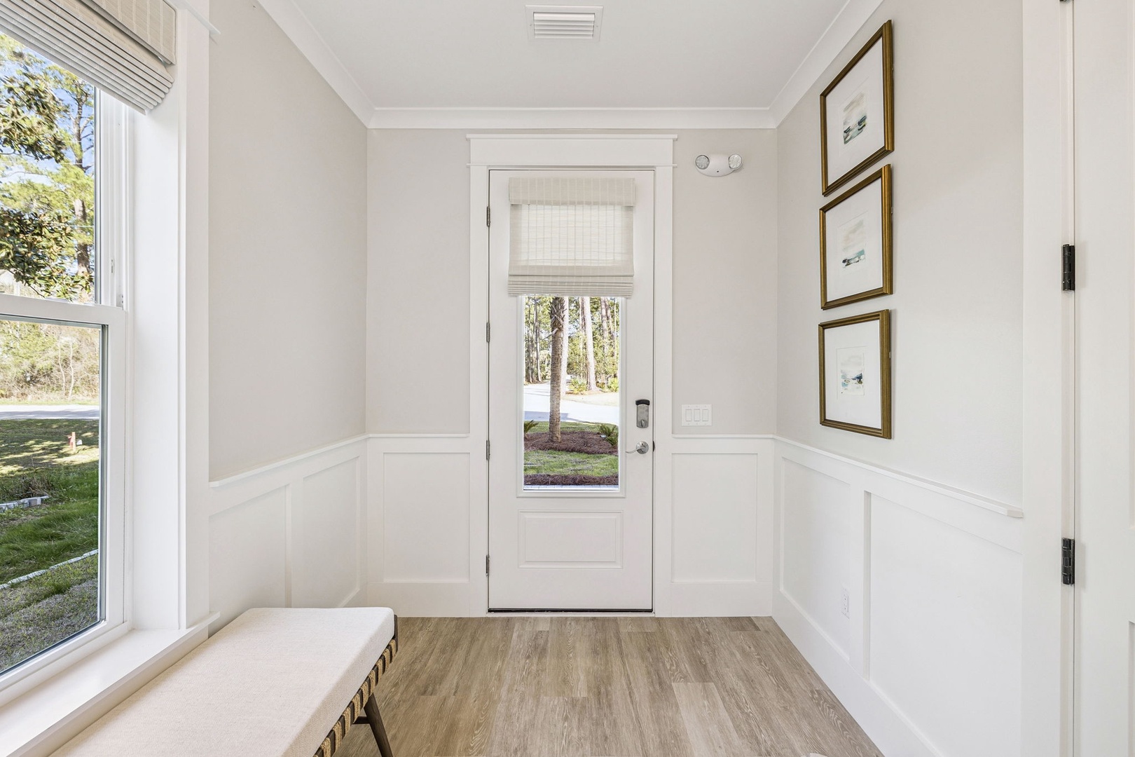 Step into your elegant entrance where natural light fills the pristine white foyer, creating a perfect welcome home feeling.