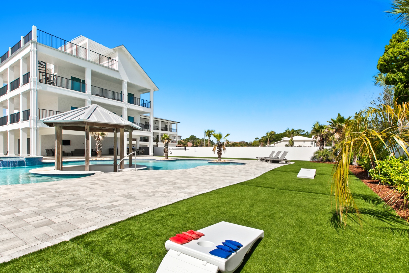 This striking property features expansive grounds with a stunning swimming pool, covered pavilion, and lush green lawn—perfect for soaking up sunshine or gathering with friends and family under the Florida sky.