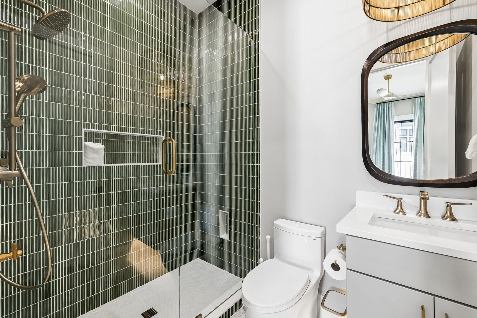 Step into your beautifully appointed bathroom, where emerald-green tiles create a spa-like atmosphere. Enjoy the spacious walk-in shower, modern fixtures, and elegant finishes designed for your comfort.