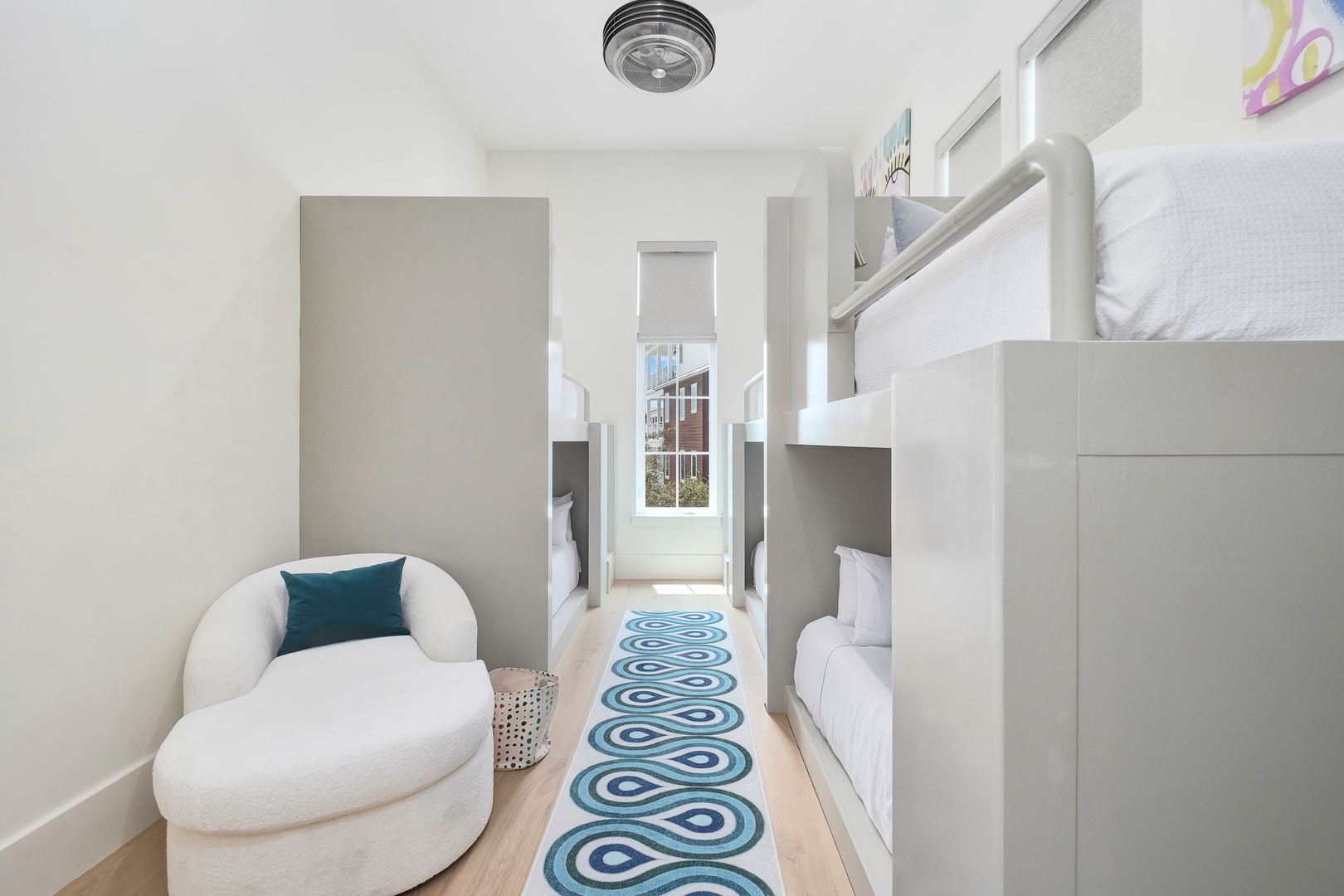 Tuck your little ones in at night in this cozy bunk room, complete with smart built-in storage and a cheerful runner that makes bedtime feel like an adventure.