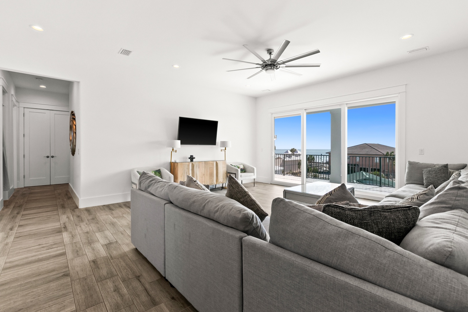 Settle into your spacious living room with stunning ocean views just beyond your balcony doors. High ceilings and soft natural light create a bright, welcoming retreat perfect for relaxation.