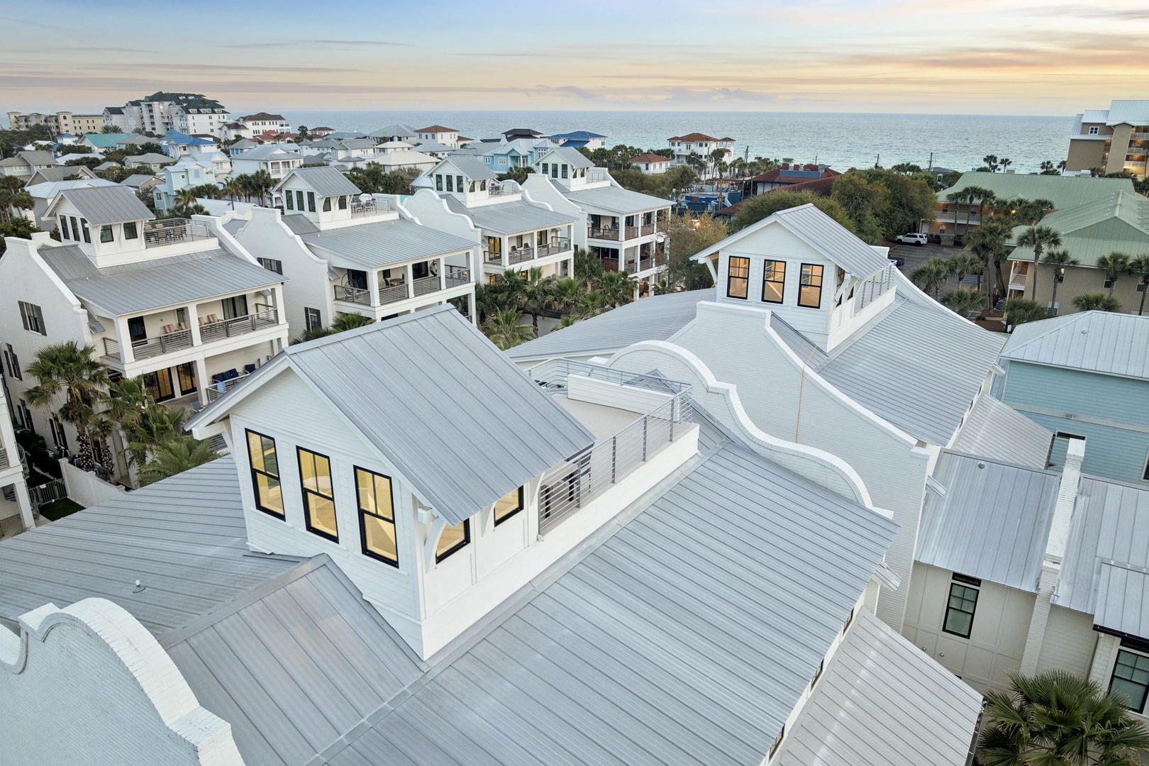 Stunning aerial view of this modern coastal retreat nestled among charming beach homes, just moments from pristine shores.