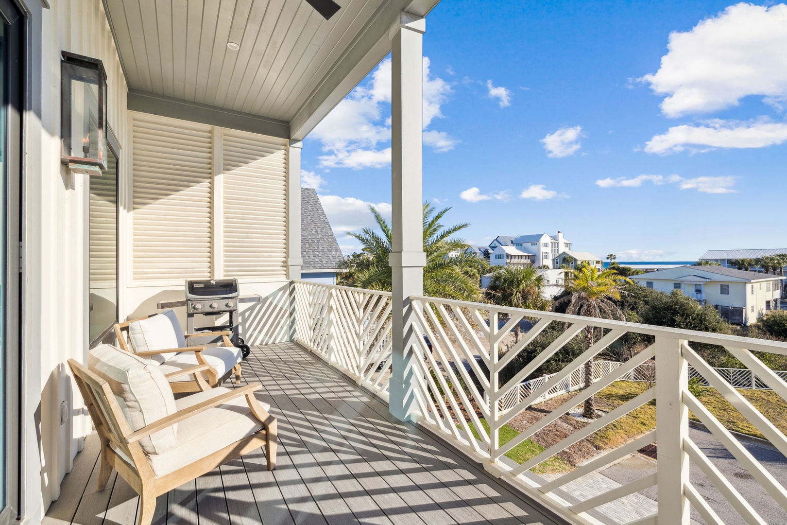 Relax on your private balcony with comfortable seating and coastal views, complete with a barbecue grill for perfect outdoor dining moments.