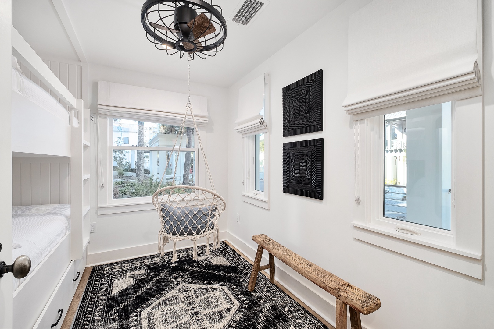 Your bright corner retreat features a cozy hanging chair and rustic bench, perfect for morning coffee or quiet reading moments.