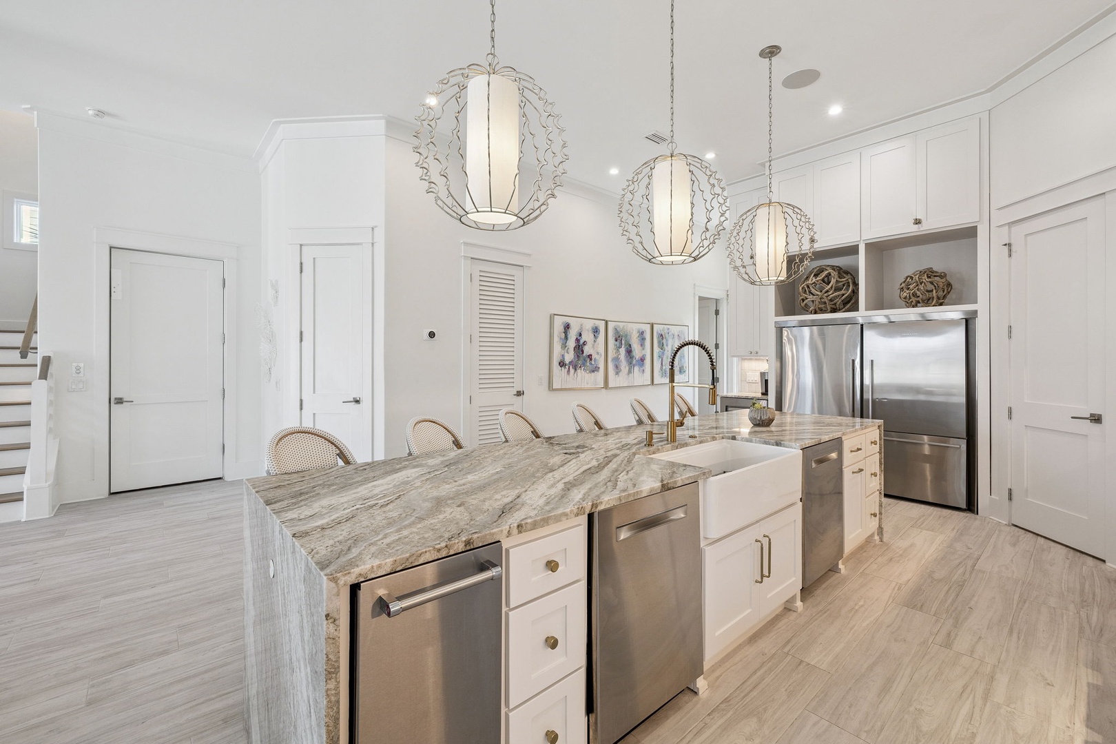 Your bright, elegant kitchen features marble countertops, modern appliances, and pendant lighting - perfect for preparing meals together.