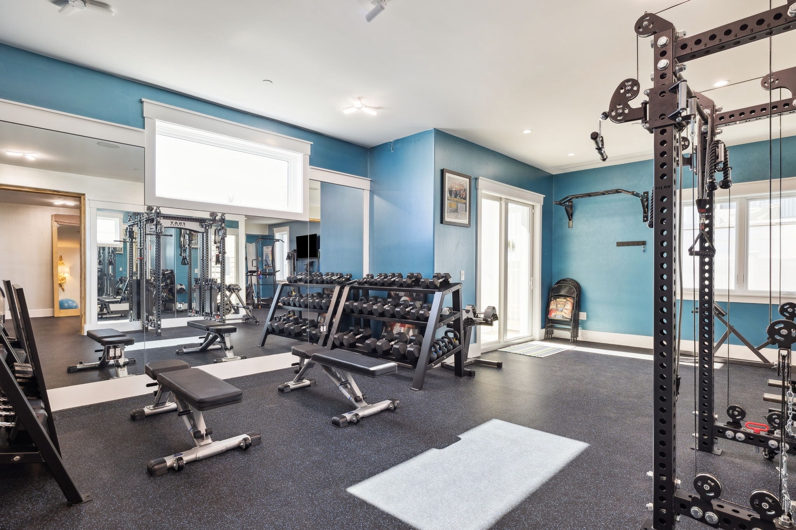 Your private fitness sanctuary awaits with professional-grade equipment, calming blue walls, and everything you need for an energizing workout.