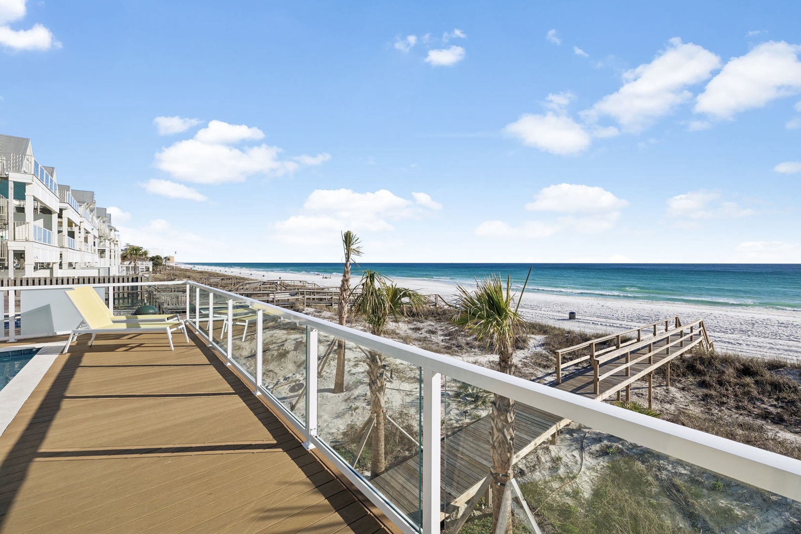 Beachfront property features direct access to pristine white sand beaches and turquoise waters through scenic boardwalk pathways.