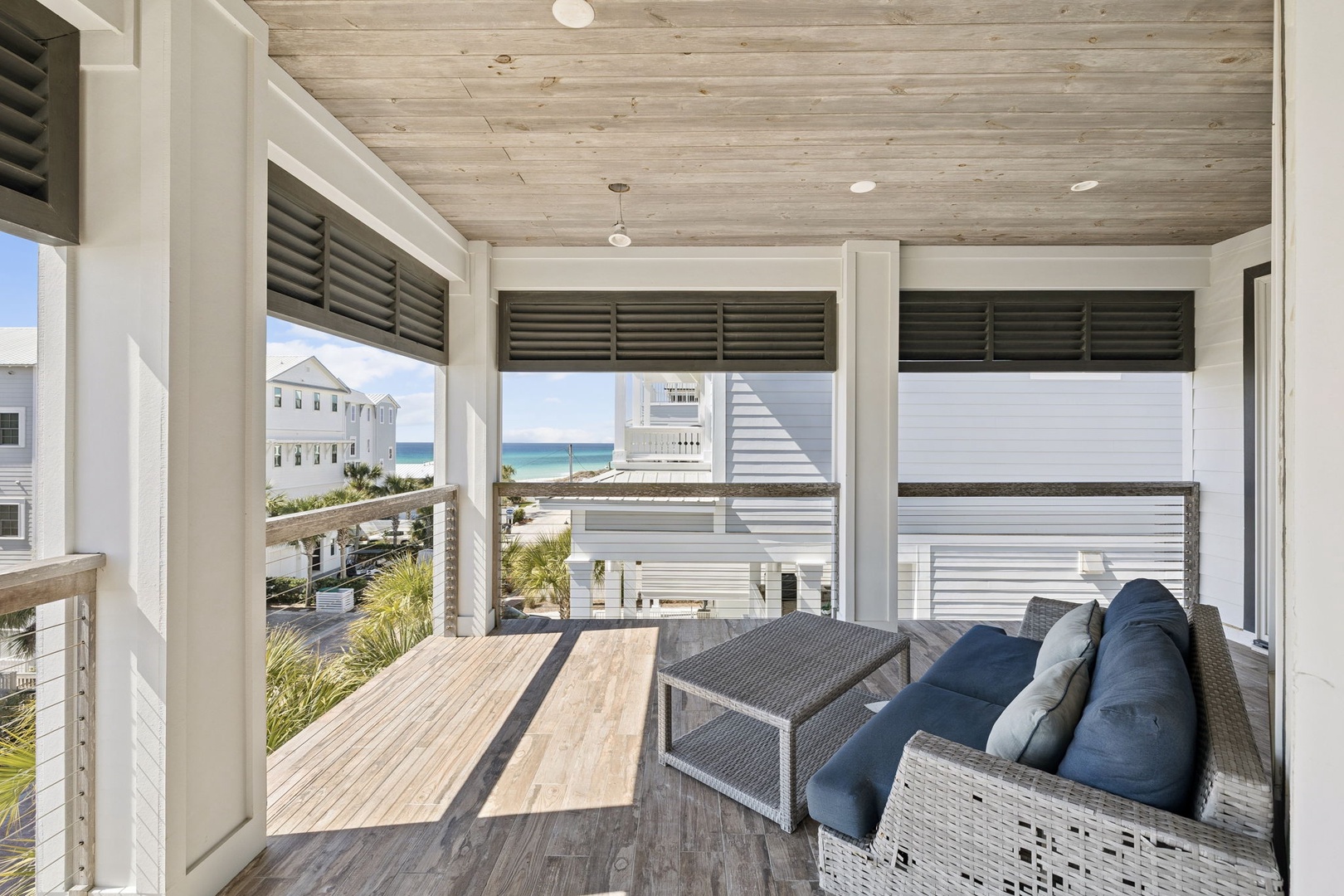 Unwind on your private screened porch with ocean glimpses, comfortable seating, and coastal breezes flowing through.