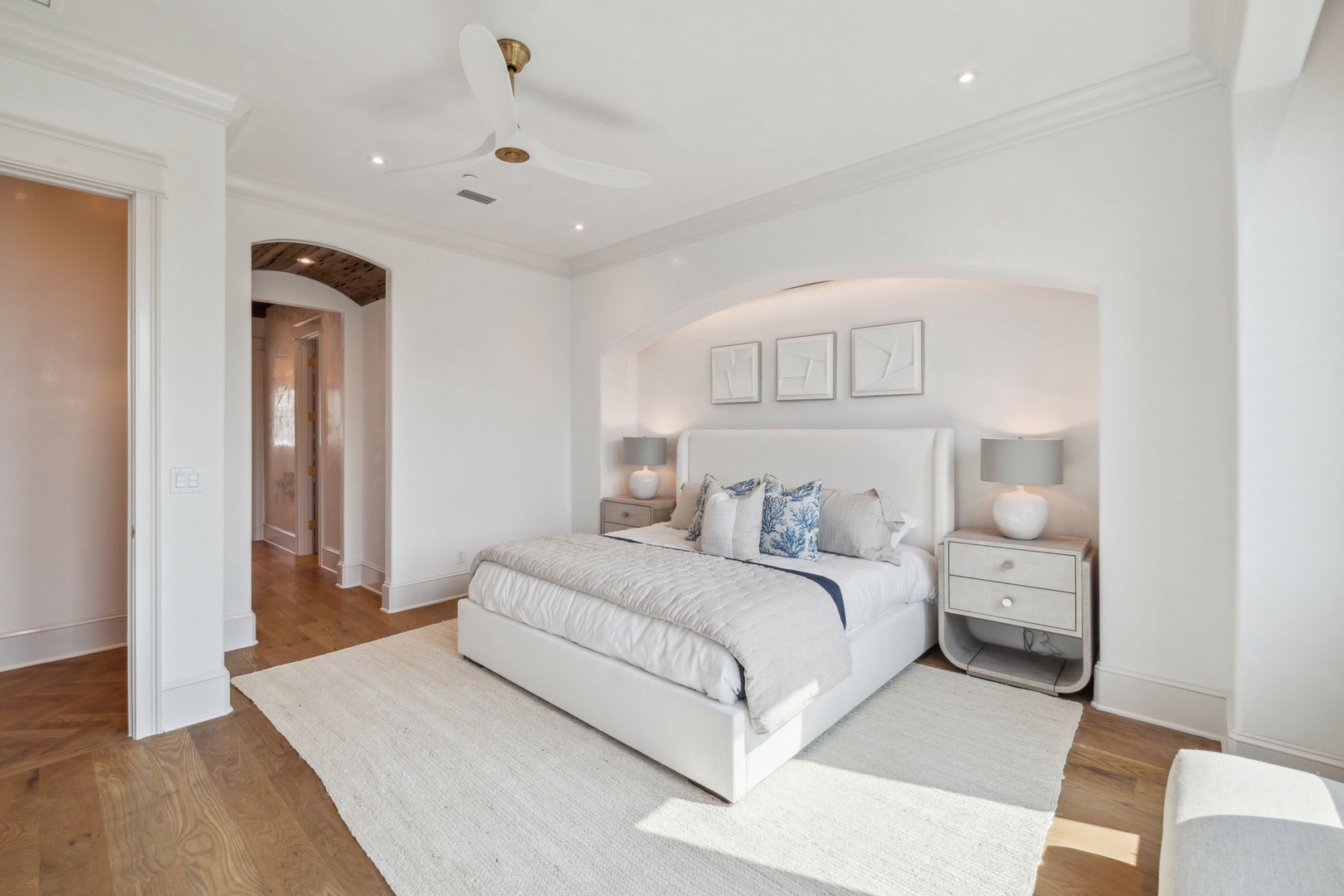 Unwind in your serene bedroom, where soft white linens and elegant décor create a peaceful retreat for restful nights.