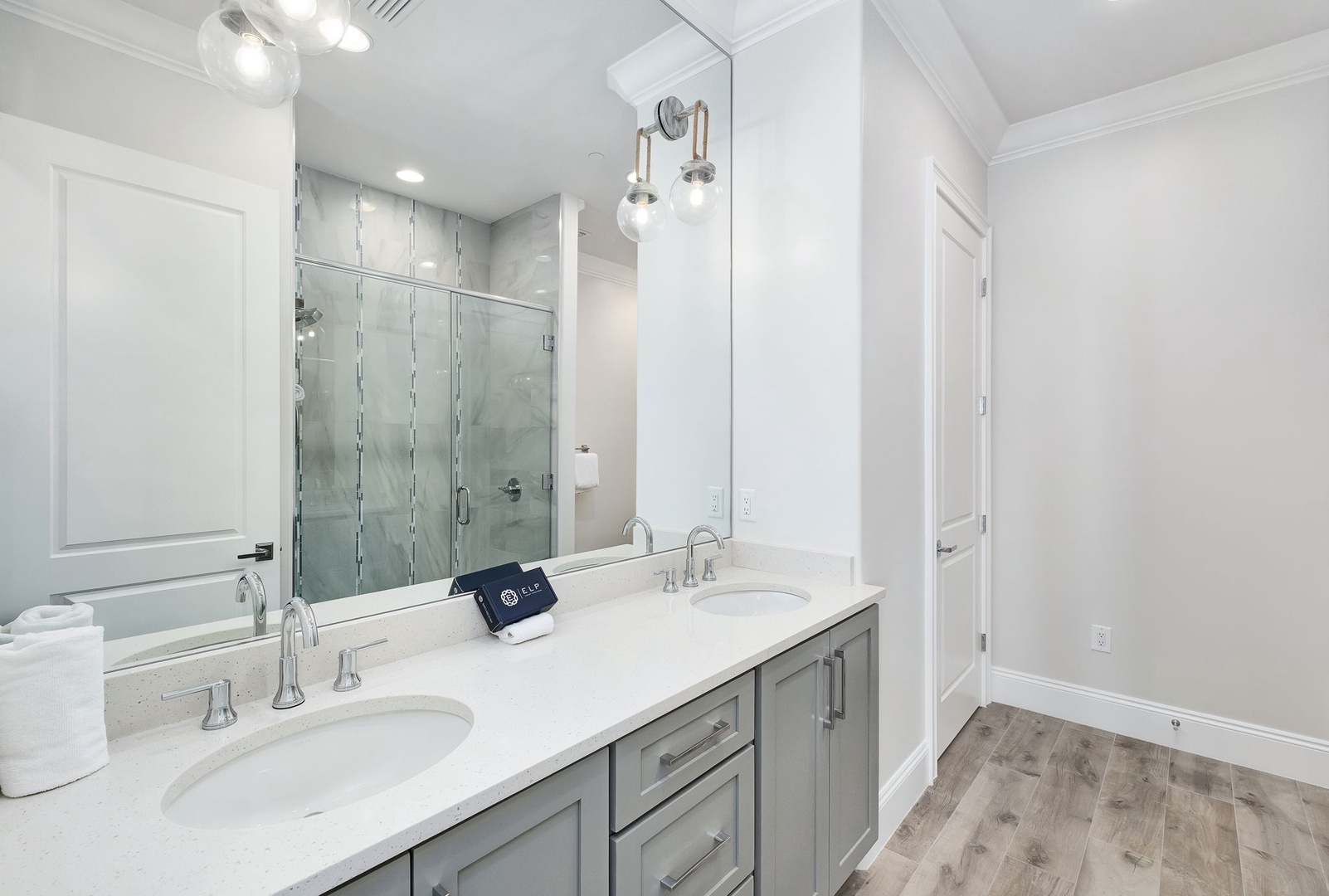 Your elegant ensuite features dual vanities, a luxurious glass-enclosed shower, and sophisticated finishes for a spa-like morning routine.