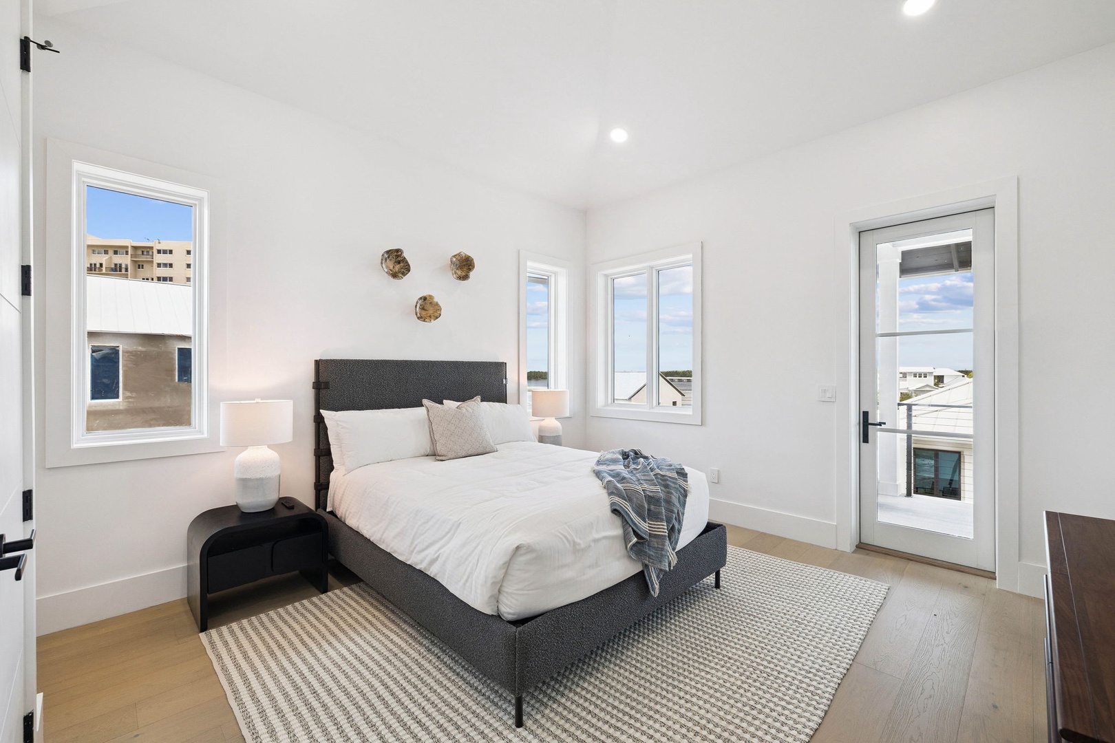 Wake up in a bright, peaceful bedroom with a plush bed, vaulted ceilings, and abundant natural light. Step through your private door onto the balcony for morning air.