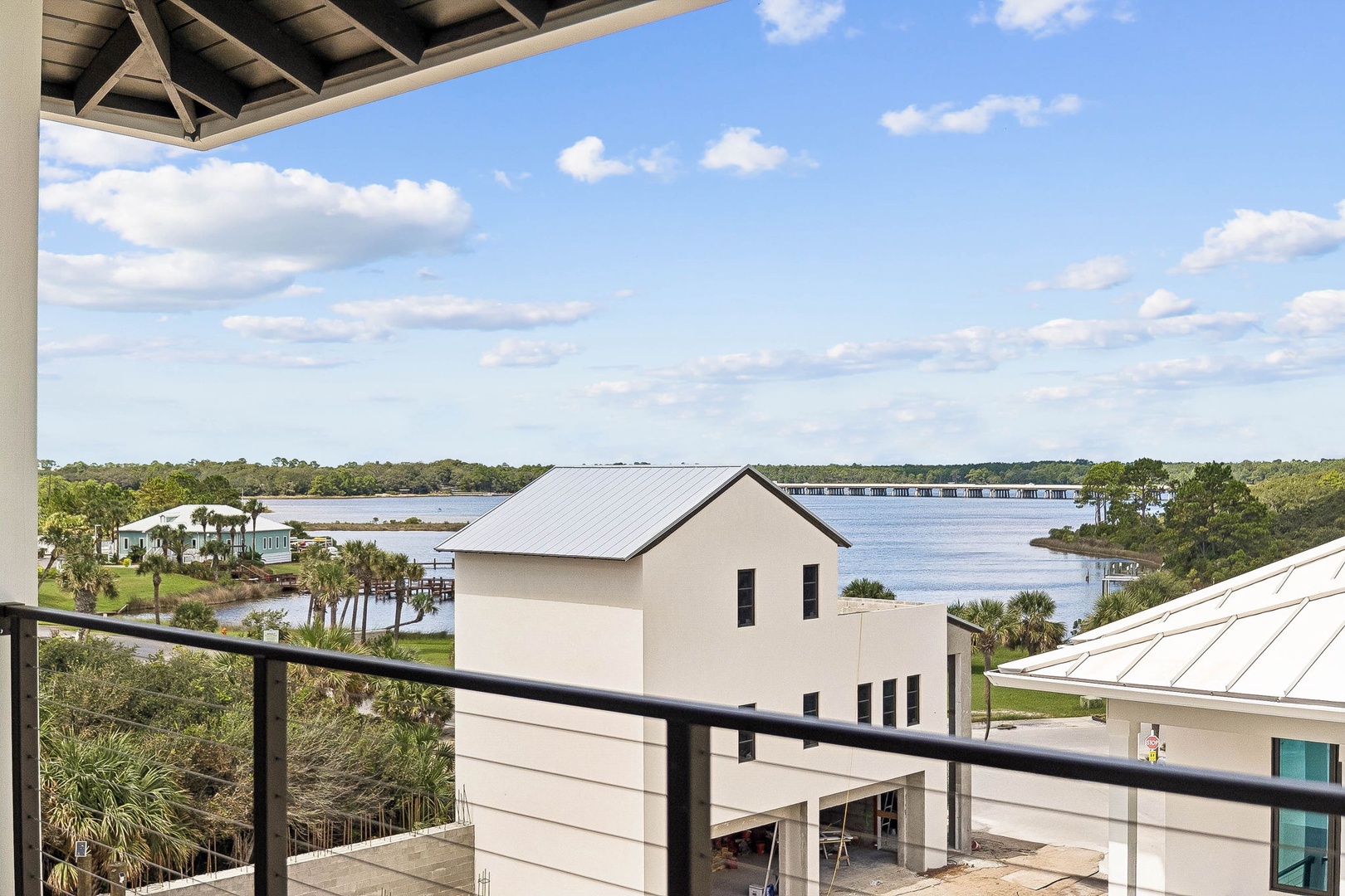Step out onto your private balcony and take in peaceful views of the river, lush coastal vegetation, and neighboring homes dotting the shoreline under Florida's endless sky.