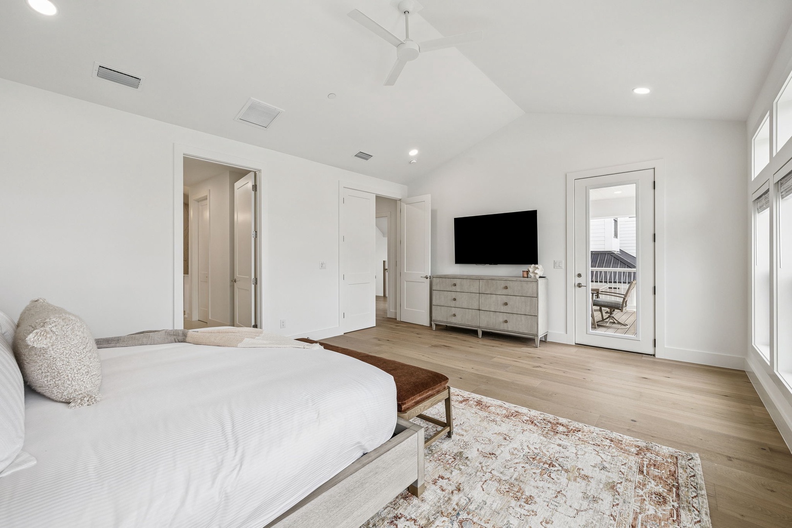 Unwind in your spacious bedroom with crisp linens, private balcony access, and entertainment setup for ultimate relaxation.