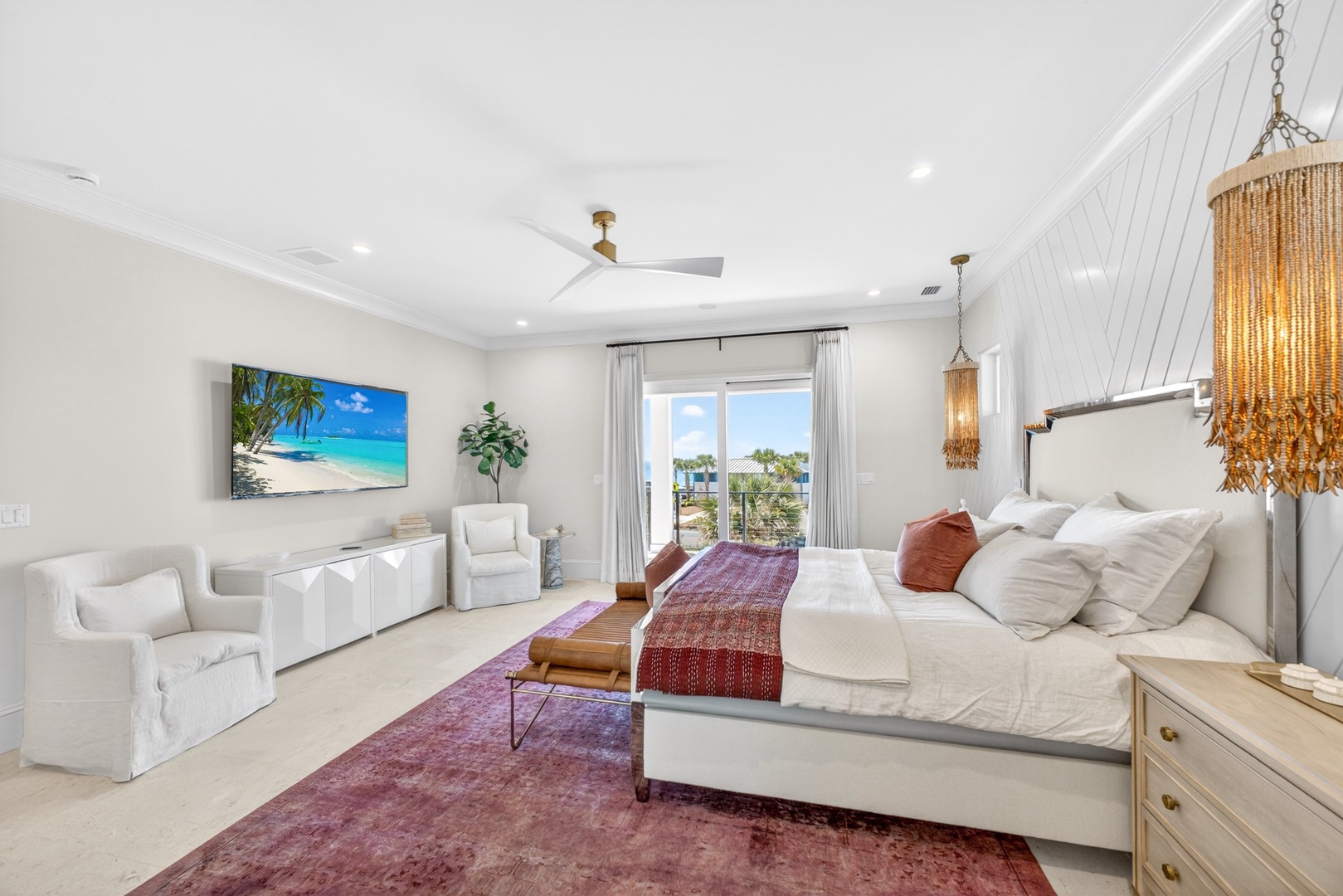 Your spacious master suite blends coastal elegance with comfort, featuring plush bedding, stylish fixtures, and a wall-mounted TV for unwinding after beach days.
