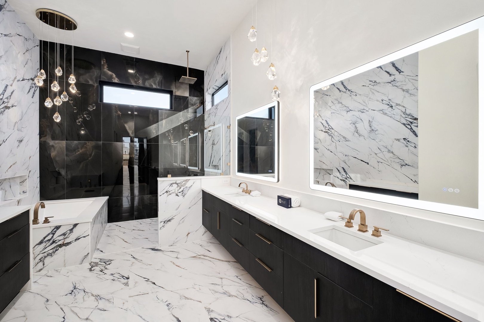 Immerse yourself in luxury with stunning marble surfaces, a soaking tub, and elegant pendant lighting creating your personal spa retreat.