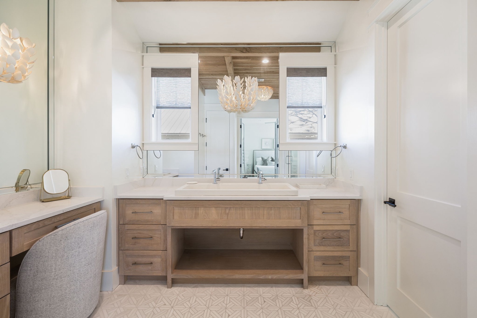 Your spa-like bathroom features a stunning double vanity with elegant lighting, creating the perfect space to refresh each morning.
