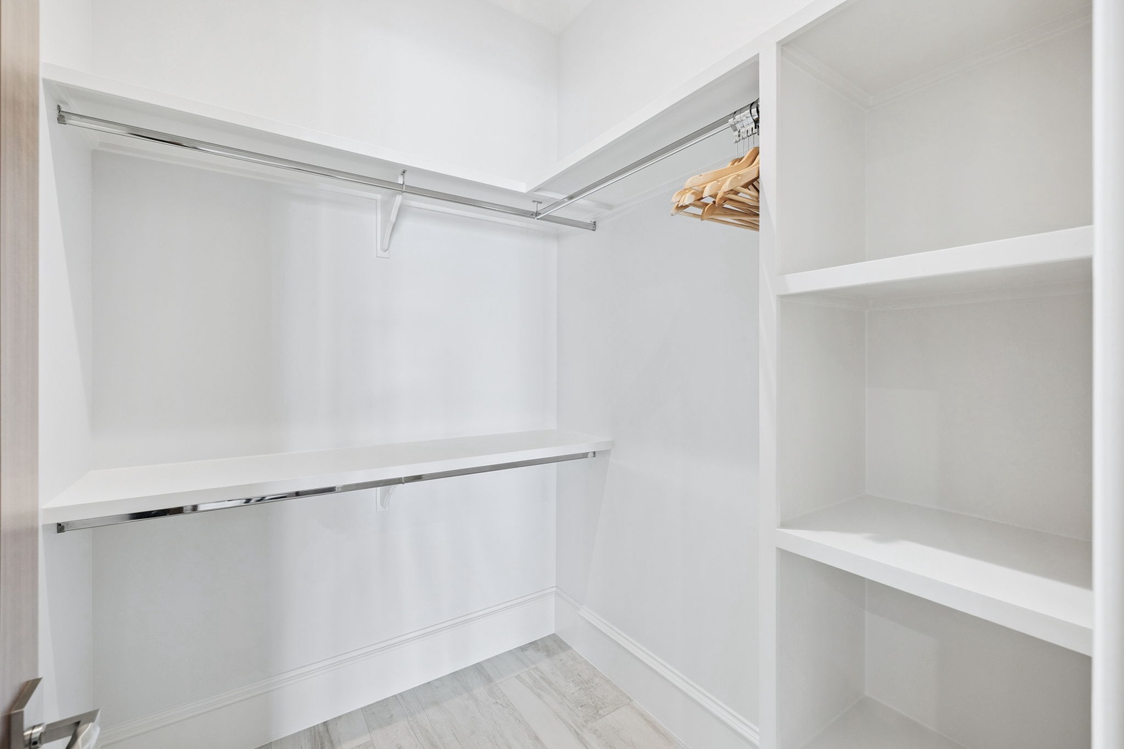 Your spacious walk-in closet offers ample storage with dual hanging rods and built-in shelving for all your belongings.