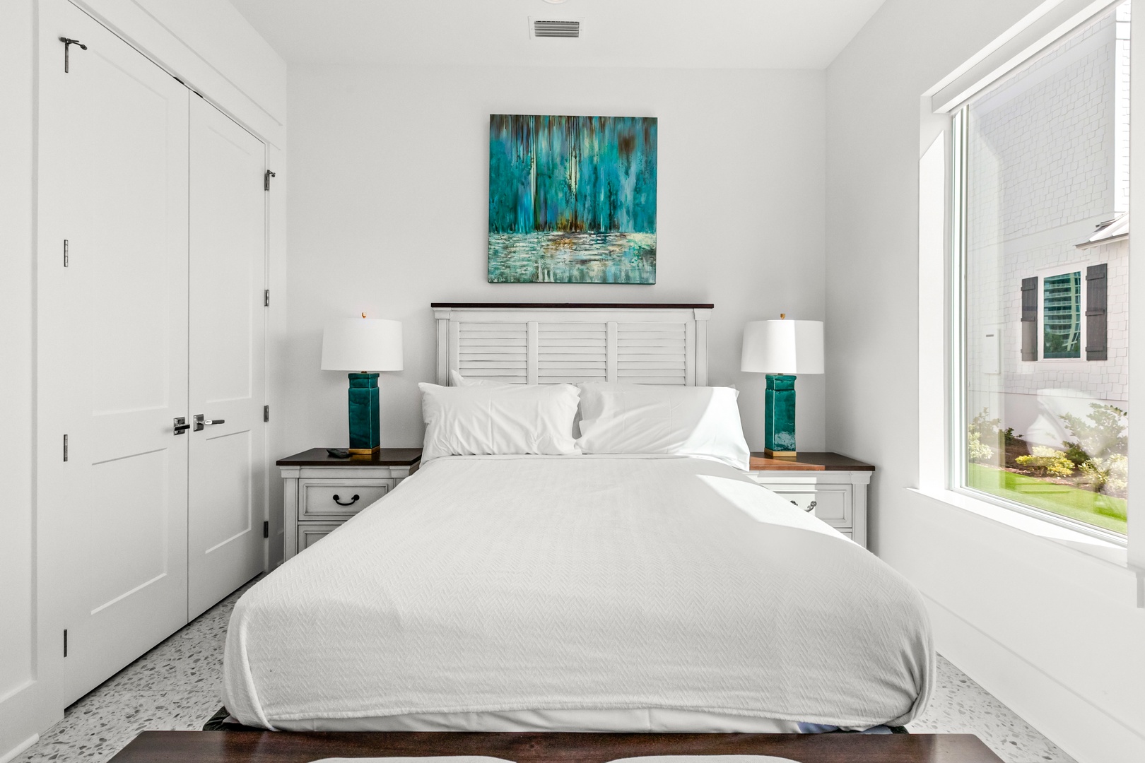 Sink into crisp white linens and wake to soft natural light streaming through your window. Coastal-inspired accents in calming teal tones create a serene retreat where you'll drift off to peaceful sleep.