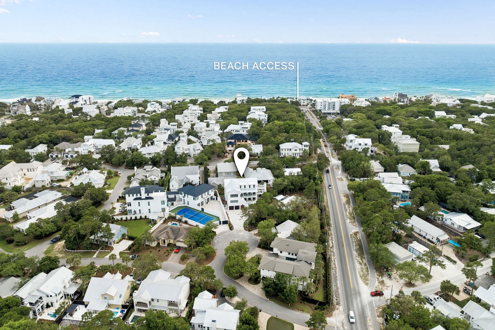 Coastal retreat with direct beach access, nestled among lush greenery in a charming beachside community just steps from pristine turquoise waters.